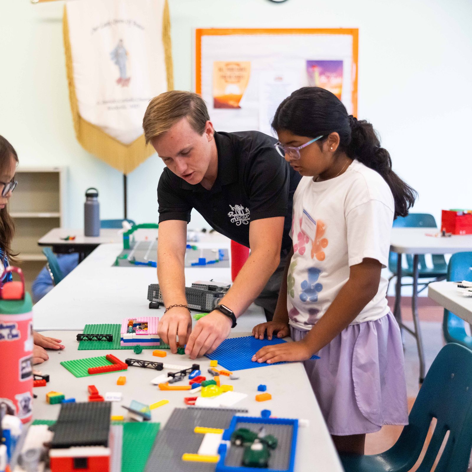 Simon Capion, a seminarian for the Archdiocese of Washington, works with campers during a LEGO masters activity at the Rockville Catholic Summer Program on Aug. 5 at St. Patrick’s Parish. (Catholic Standard photo by Andrew Biraj)
