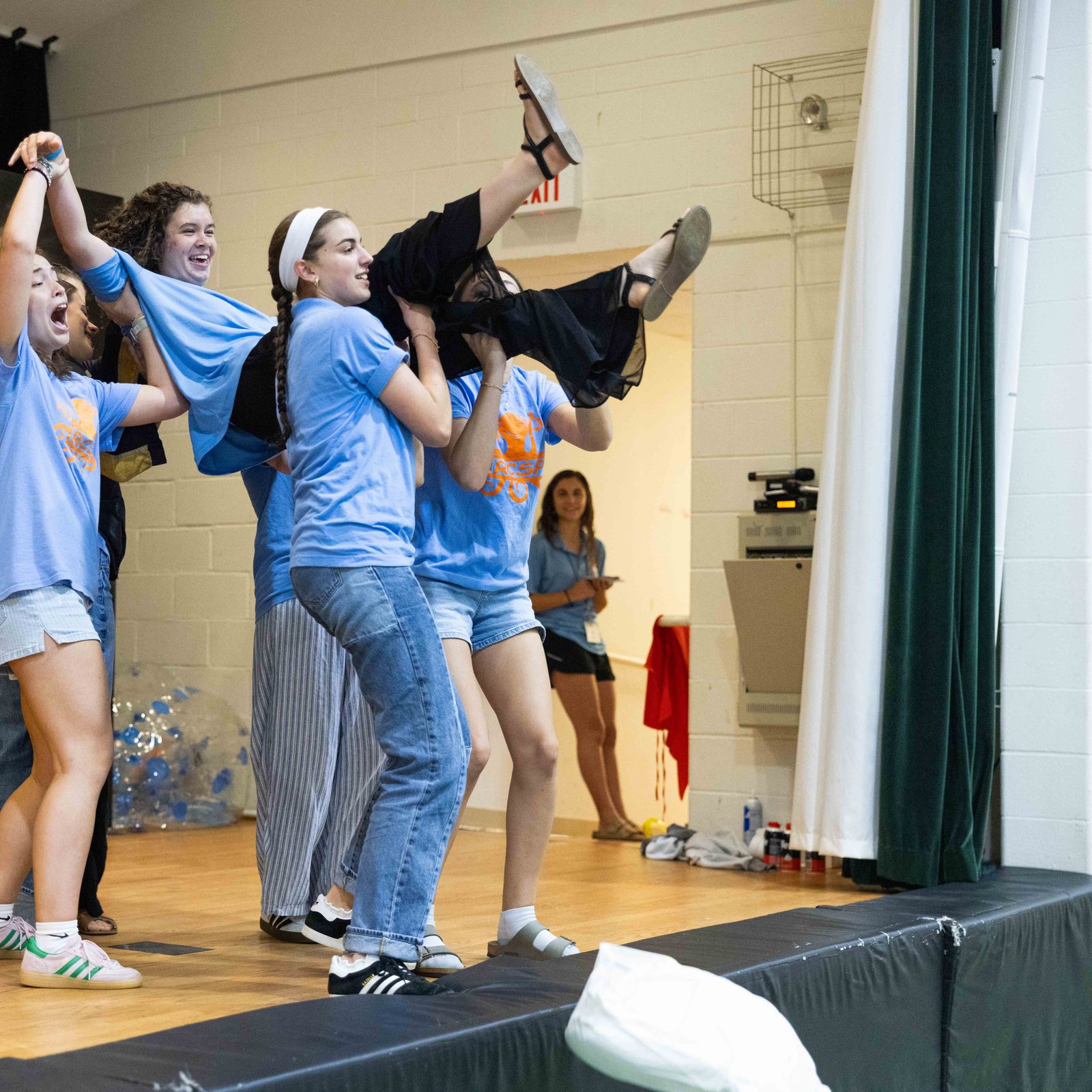 Counselor Margaret Nealy is lifted by fellow counselors Tessa Rottkamp and Maria Eckenrode as they perform a lip-synching skit at the Rockville Catholic Summer Program on Aug. 5 at St. Patrick’s Parish. (Catholic Standard photo by Andrew Biraj)