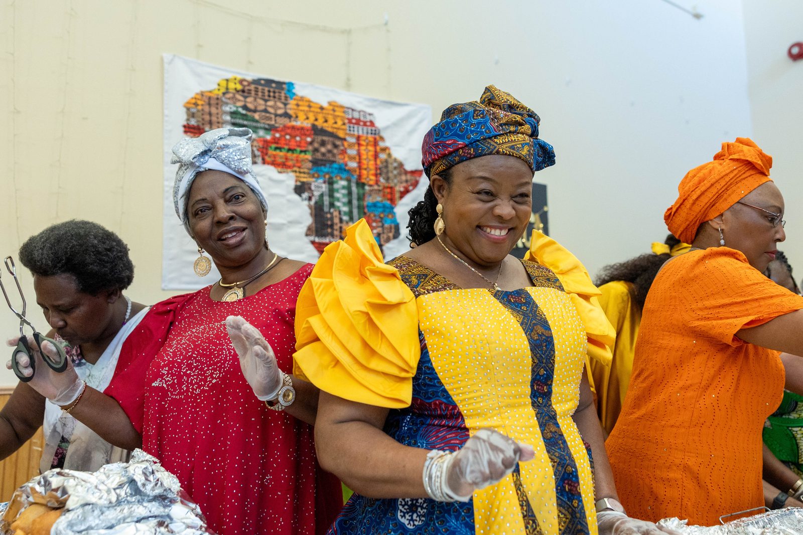 Women serve traditional African food at a June 30 reception marking the 50th anniversary of Mother Seton Parish in Germantown, Maryland. (Catholic Standard photos by Mihoko Owada)