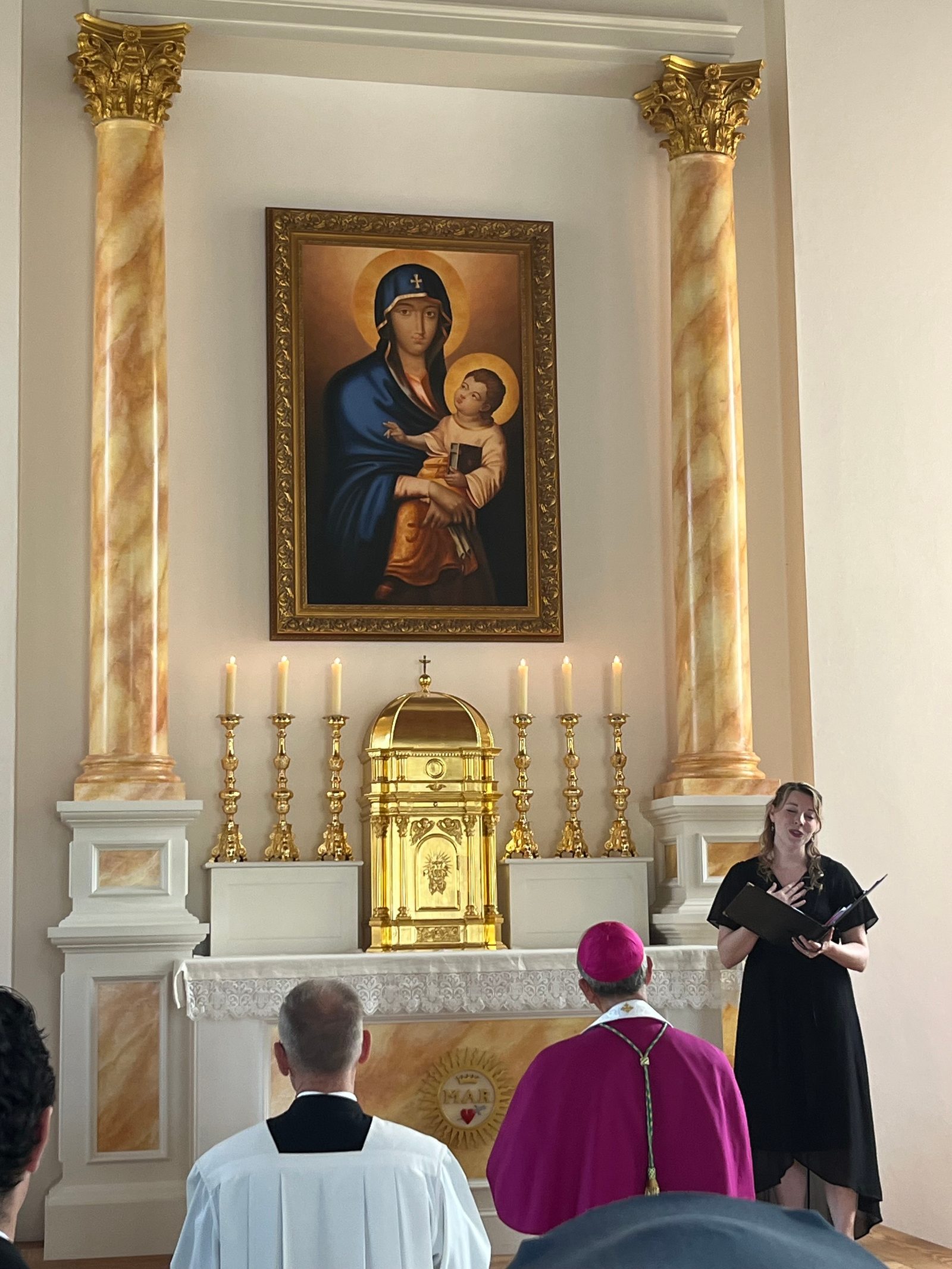 Jennifer Linhart Wood – the choral director of Trinity Episcopal Church in St. Mary’s City who is an assistant professor of English at George Mason University – sings the Salve Regina at the conclusion of the reinterment rite at the rebuilt 1667 Brick Chapel in Historic St. Mary’s City on Sept. 20,2025 that marked the return of the remains of eight young children from colonial-era Maryland to the site where they had been buried. In the early 1990s, the remains of 65 early Marylanders buried near the foundation of the original chapel were removed so they would not be damaged during the construction of the rebuilt chapel. (Catholic Standard photo by Mark Zimmermann)