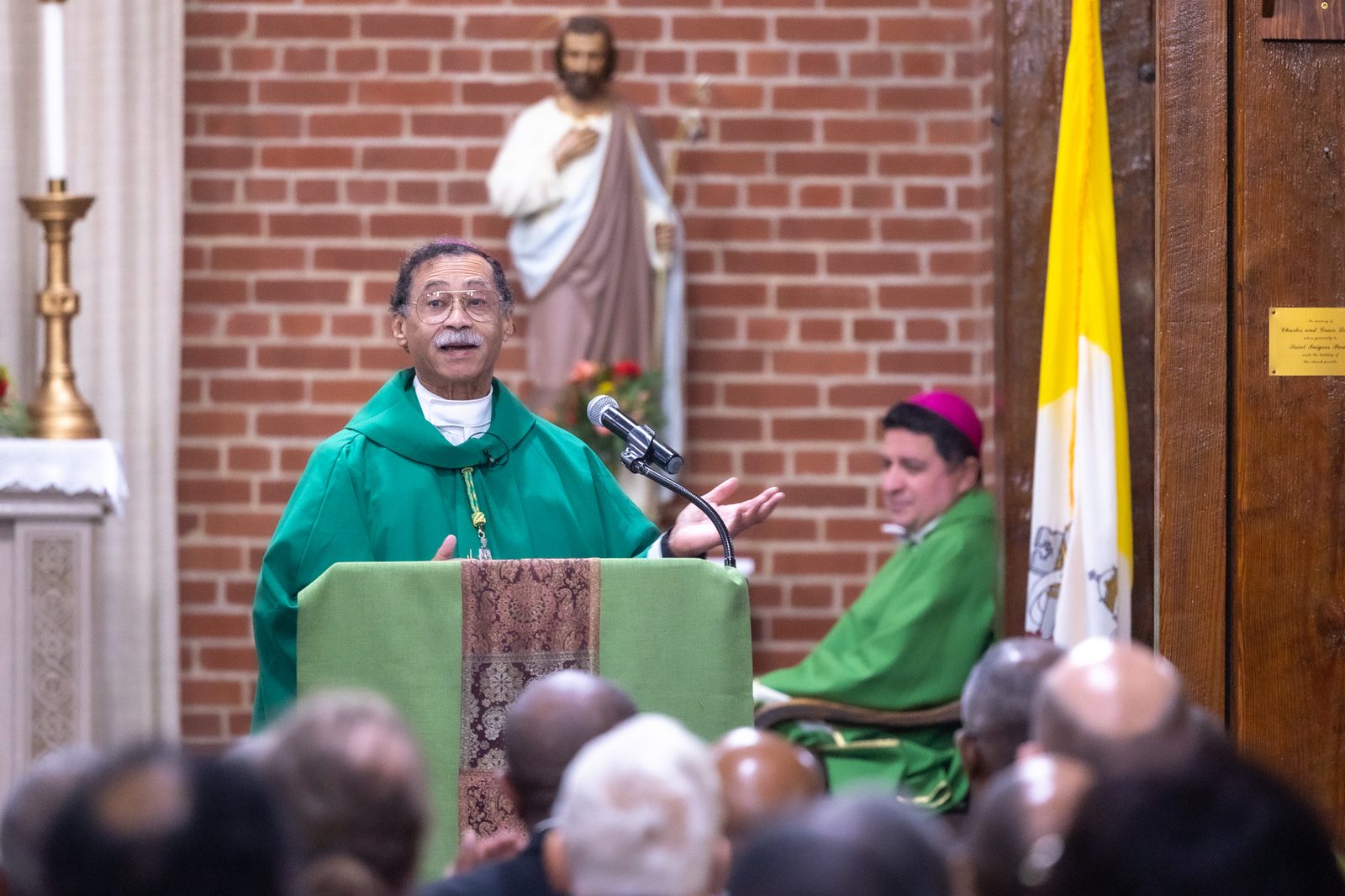 Washington Auxiliary Bishop Roy Campbell Jr. gives the homily during a Mass to Commemorate Black Catholic History Month on Nov. 16, 2024 at St. Peter Claver Church in St. Inigoes, Maryland. Seated at right is Washington Auxiliary Bishop Evelio Menjivar, who was a concelebrant at the Mass, which was sponsored by the Office of Cultural Diversity and Outreach of The Roman Catholic Archdiocese of Washington. (Catholic Standard photo by Mihoko Owada)