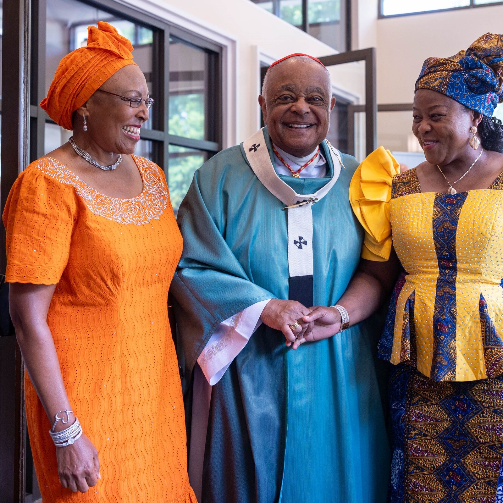 After a Mass on June 30, 2024 marking the 50th anniversary of Mother Seton Parish in Germantown, Maryland, Cardinal Wilton Gregory poses for a photo with women wearing traditional African dress. (Catholic Standard photo by Mihoko Owada)