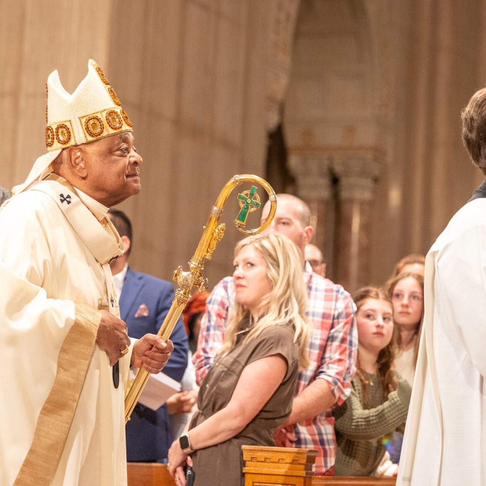 Washington Cardinal Wilton Gregory processes into the Basilica of the National Shrine of the Immaculate Conception on Easter Sunday, March 31, 2024. The Mass marked the 100th anniversary of the first Mass celebrated at the National Shrine on Easter Sunday in 1924, and to mark the anniversary, Cardinal Gregory carries the crosier of Bishop Thomas Shahan, the basilica’s first rector. Processing in front of the cardinal is Father Kevin Regan, his priest secretary. (Catholic Standard photo by Mihoko Owada)