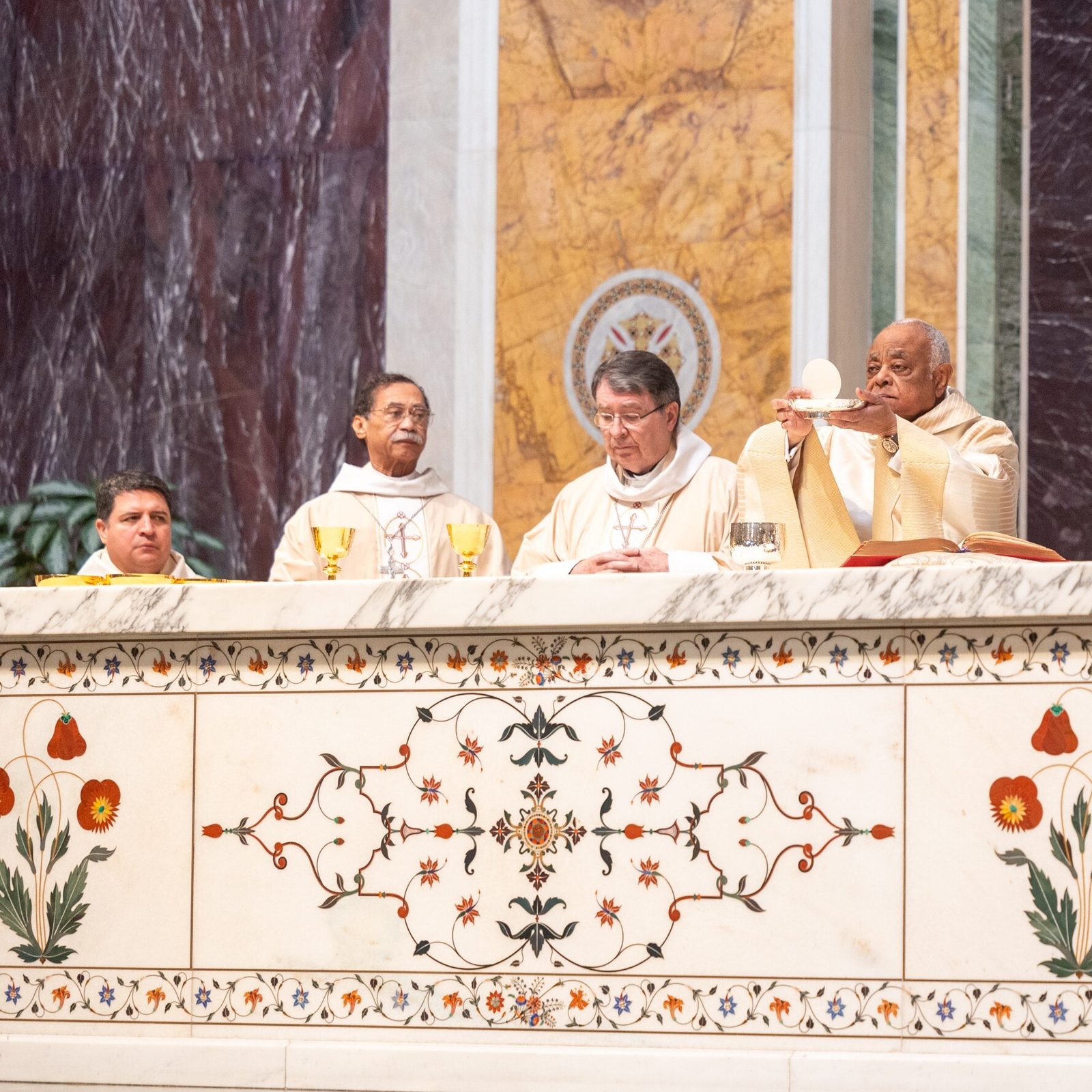 At center, Cardinal Wilton Gregory, now the apostolic administrator of The Roman Catholic Archdiocese of Washington, elevates the Eucharist during the Youth Mass for Life on Jan. 24, 2025 at the Cathedral of St. Matthew the Apostle. From left to right are Washington Auxiliary Bishop Evelio Menjivar; Washington Auxiliary Bishop Roy Campbell Jr.; Cardinal Christophe Pierre, the Apostolic Nuncio to the United States; Cardinal Gregory; Cardinal Robert McElroy, the archbishop-elect of Washington who will be installed as the archbishop of Washington on March 11; and Washington Auxiliary Bishop Juan Esposito. (Catholic Standard photo by Mihoko Owada)