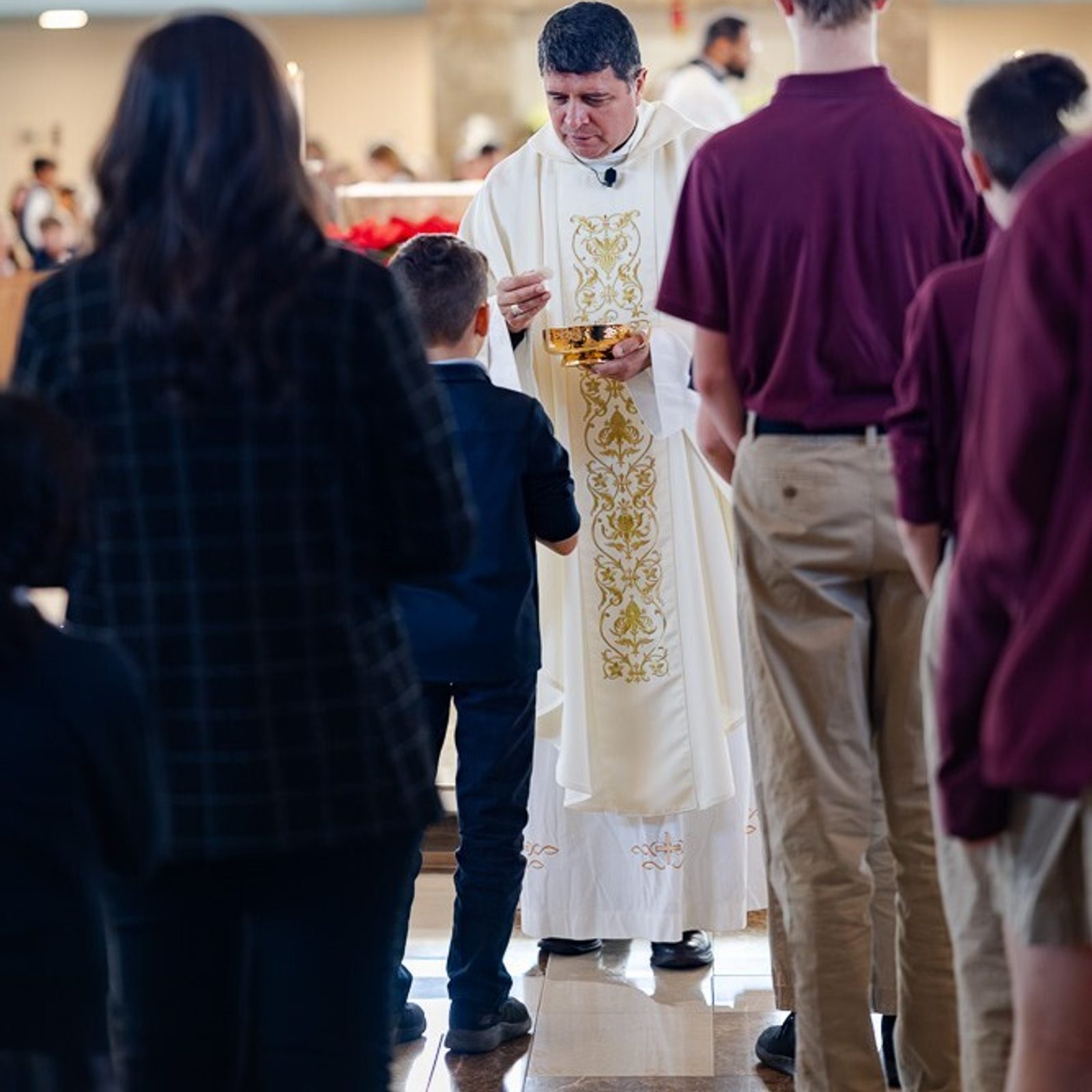Washington Auxiliary Bishop Evelio Menjivar gives Communion to students during a Catholic Schools Week Mass for St. Mary’s County Catholic schools on Jan. 22, 2026 at Immaculate Heart of Mary Church in Lexington Park, Maryland. (Catholic Standard photo by Nicole Olea)