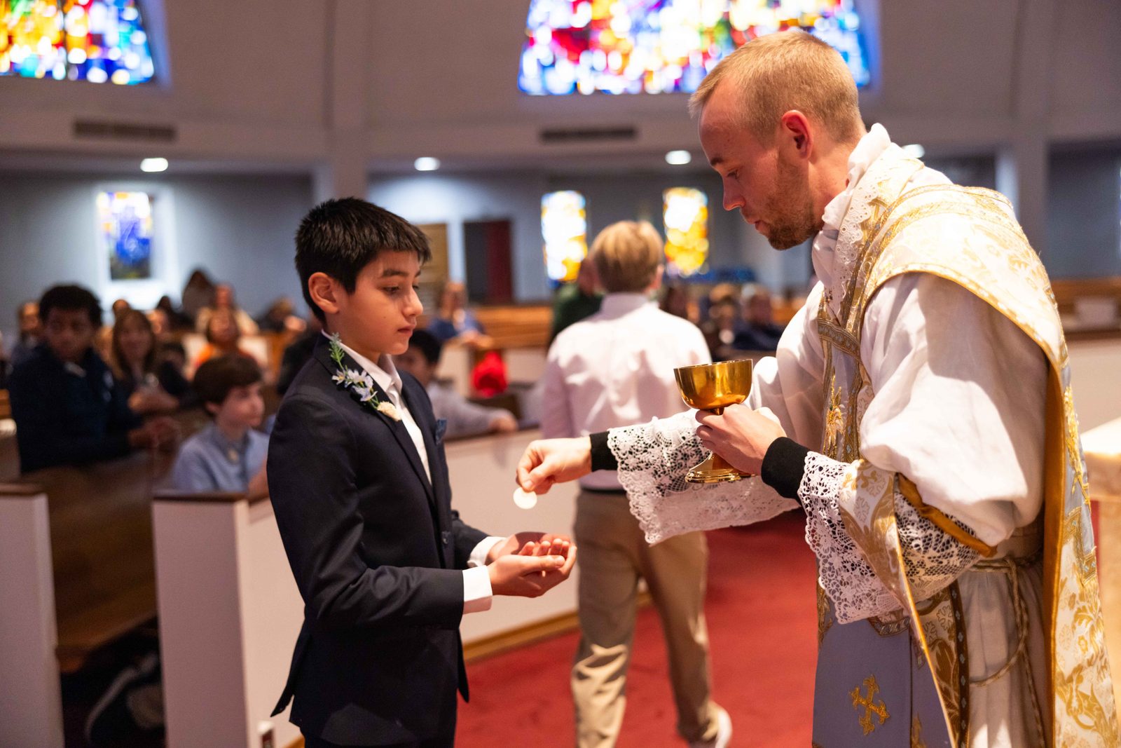 During a Mass on Jan. 31, 2025 at St. Mary’s Church in Rockville, Mason Salvado, a sixth grader at St. Mary’s School, receives his First Holy Communion from Father Nathanael Anderson, a parochial vicar at St. Mary’s who celebrated the Mass where 12 St. Mary’s students received their First Communion. (Catholic Standard photo by Andrew Biraj)