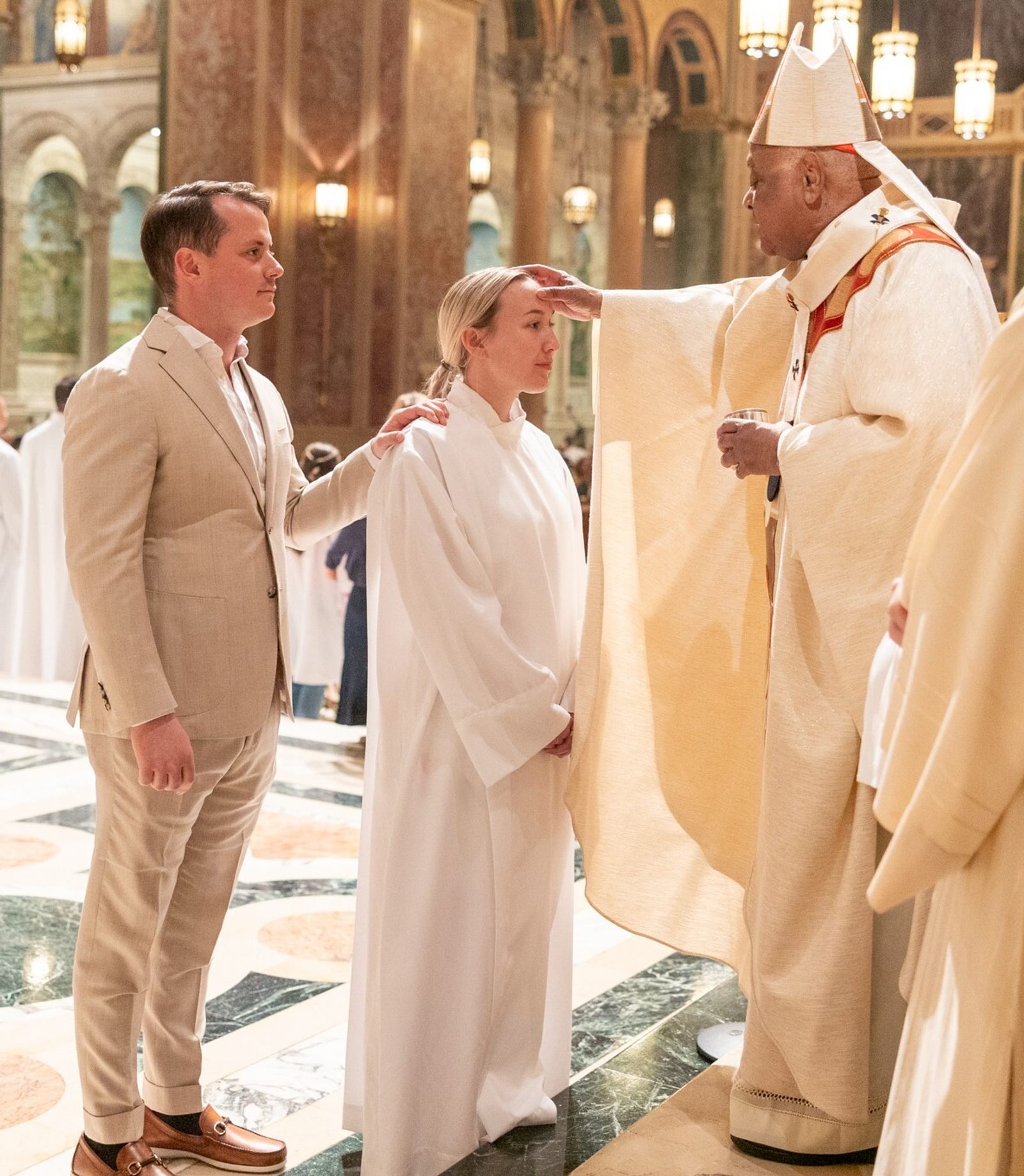 Lindsay Burns receives the sacrament of Confirmation from Cardinal Gregory during the March 30 Easter Vigil at St. Matthew’s Cathedral in Washington. (Catholic Standard photo by Mihoko Owada)