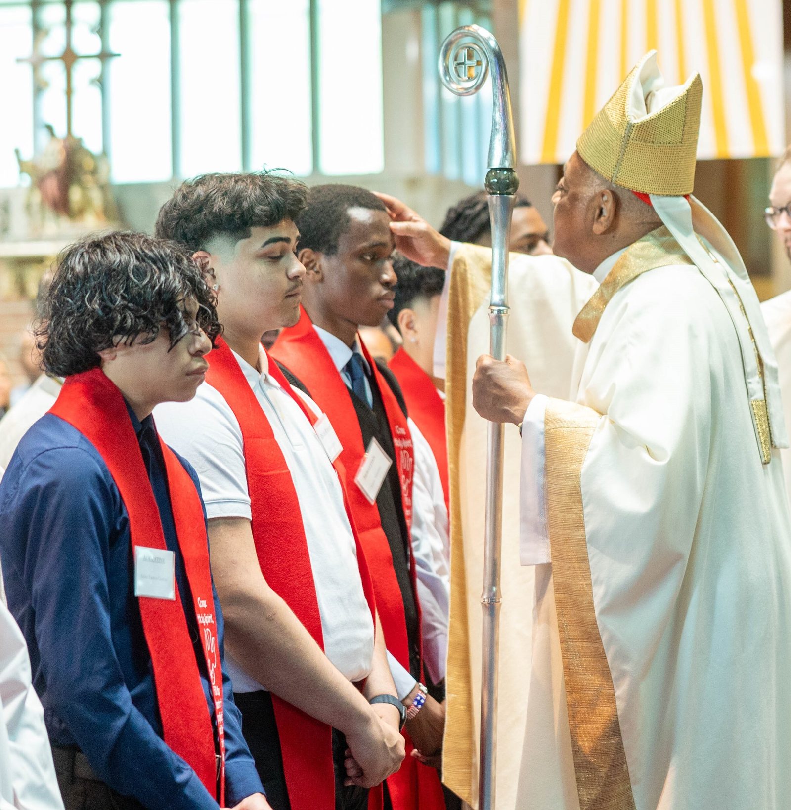 Leon Musyimi, a student at Don Bosco Cristo Rey High School in Takoma Park, receives the sacrament of Confirmation from Cardinal Wilton Gregory at a May 24 Mass at Our Lady of Sorrows Church. (Catholic Standard photo by Mihoko Owada)