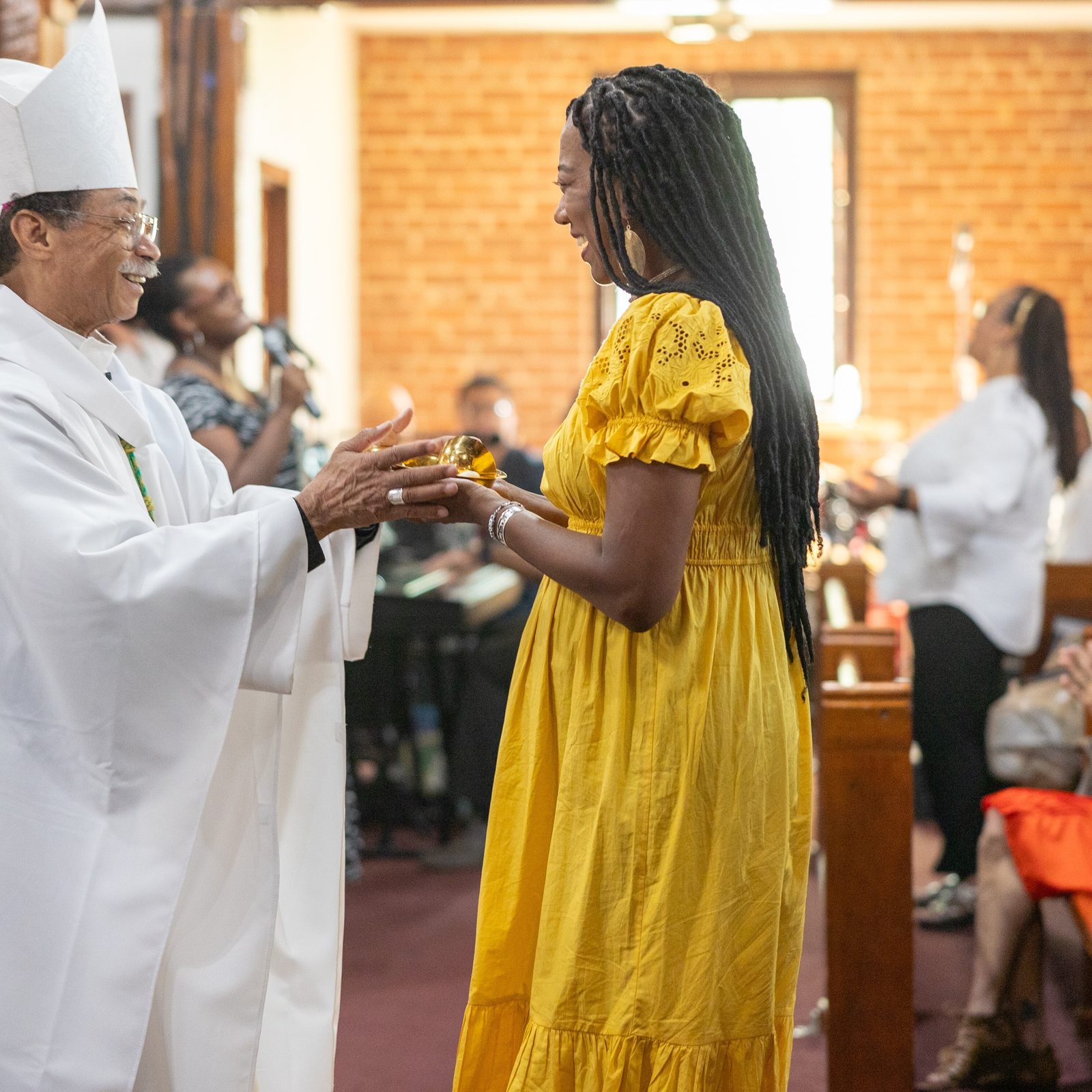 During a Sept. 3, 2023 Mass at St. Peter Claver Church in St. Inigoes, Washington Auxiliary Bishop Roy Campbell Jr. receives offertory gifts from Julie Hawkins Ennis, a co-chair of the Reclamation Project’s Southern Maryland GU272 – Jesuit Enslaved Descendant Gathering that brought together descendants of 272 enslaved people sold by Jesuits in 1838 to Louisiana plantation owners with descendants of enslaved family members who remained then at that religious order’s Maryland plantations. This photo appeared in a series of articles that received a first place award for best in-depth news/special reporting in the 2024 Catholic Media Awards competition sponsored by the Catholic Media Association. (Catholic Standard photo by Mihoko Owada)