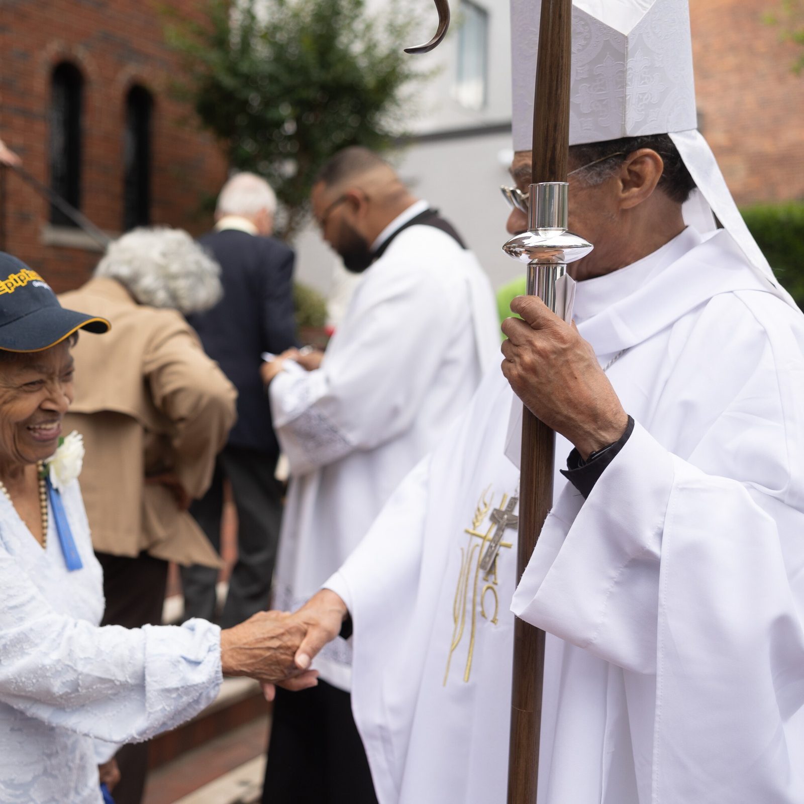 Dorothy Harris Gray – whose mother, Dorothy Williams Harris, was among the founders of Epiphany Parish in Washington, D.C., in 1925 – greets Washington Auxiliary Bishop Roy Campbell Jr. after a Mass on May 18, 2025 celebrating the parish’s 100th anniversary. African American Catholics facing discrimination at Holy Trinity Parish in Georgetown founded Epiphany Parish a century ago. (Catholic Standard photo by Mihoko Owada)