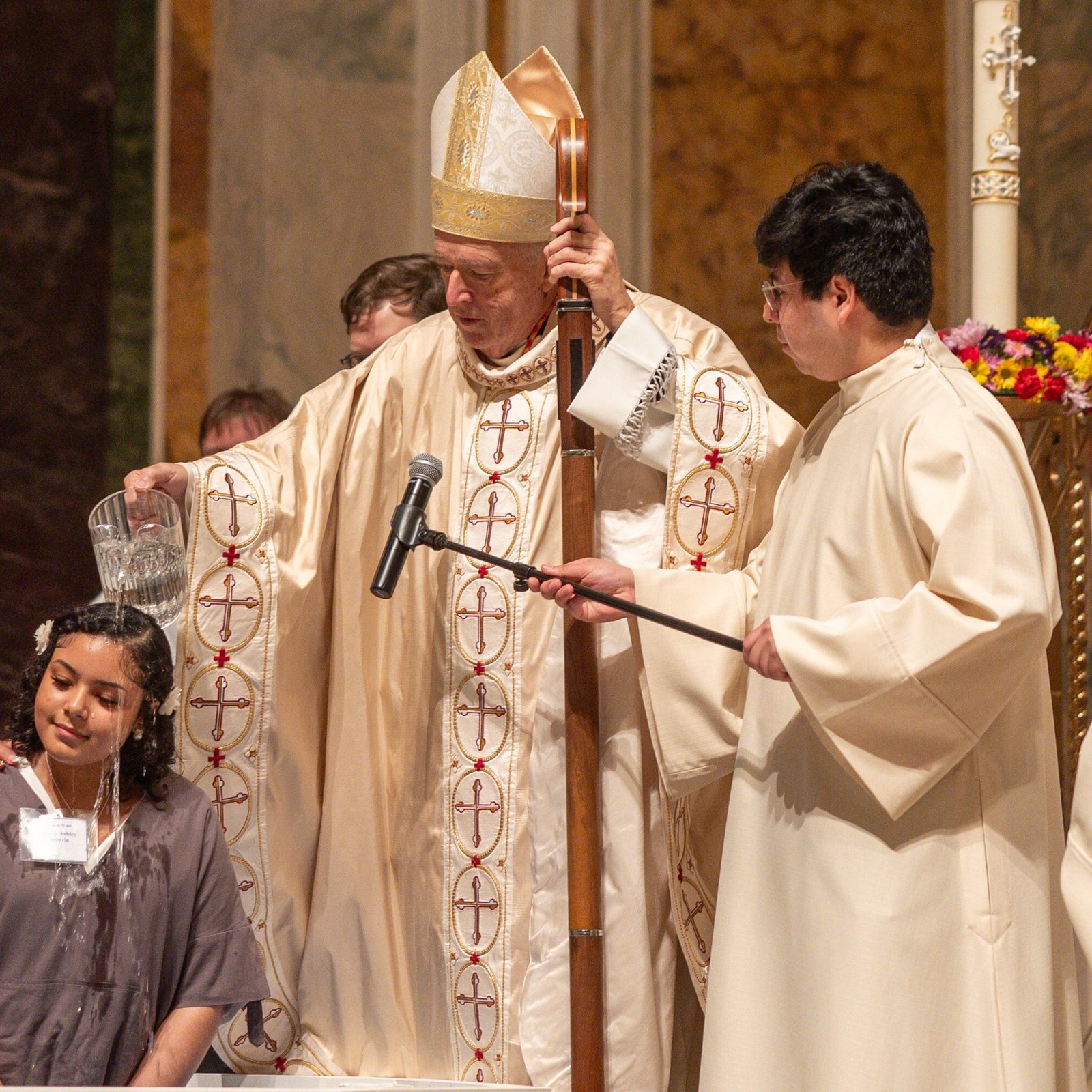 Jenny Ashley Segovia Gonzalez is baptized by Washington Cardinal Robert W. McElroy during the Easter Vigil on April 19, 2025 at the Cathedral of St. Matthew the Apostle. Eight people were baptized at the cathedral that evening. They were among 25 people receiving the Sacraments of Initiation at St. Matthew’s Cathedral during the Easter Vigil, becoming full members of the Catholic Church. (Catholic Standard photo by Mihoko Owada)