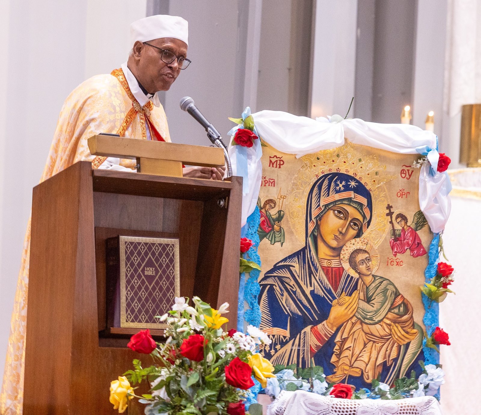 Father Tesfamariam Baraki, who earlier served as the founding pastor of Kidane-Mehret Parish for Ethiopian Catholics in the Archdiocese of Washington, speaks at a Mass on Aug. 24, 2025 at Holy Spirit Church in Forestville, Maryland that marked the feast day of the Assumption of the Blessed Virgin Mary and also marked Holy Spirit Church being the new home for that community. Father Baraki now serves as a chaplain at Howard University Hospital in Washington. (Catholic Standard photo by Mihoko Owada)