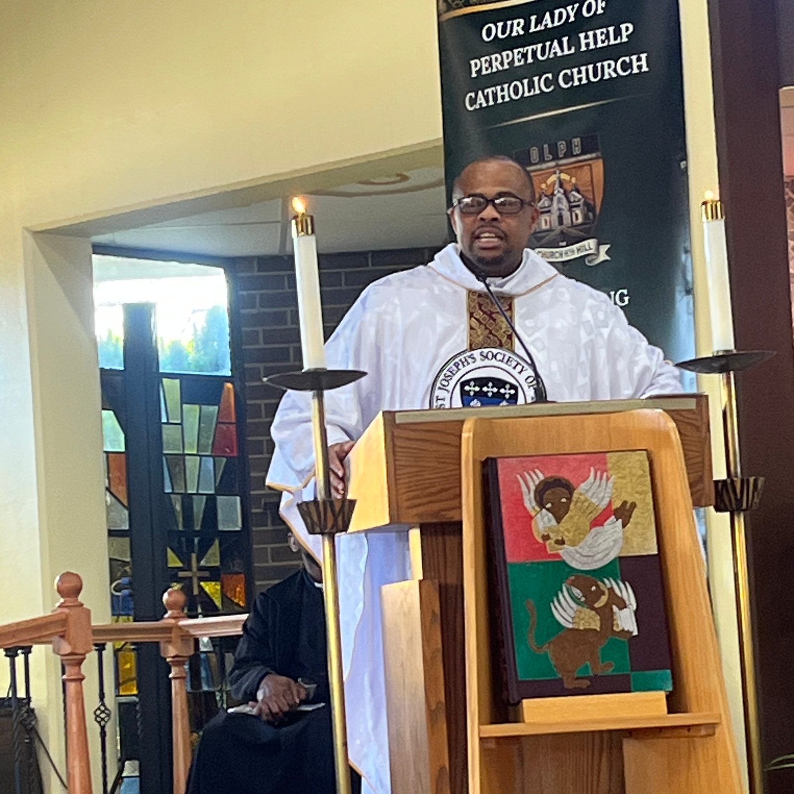 Josephite Father Cornelius K. Ejiogu speaks during the Funeral Mass for Josephite Father William L. Norvel Jr. on March 18, 2026 at Our Lady of Perpetual Help Church in Washington, D.C. Father Ejiogu, the pastor of Our Lady of Perpetual Help, said that he and fellow Josephite seminarians in Nigeria regarded the priest as a father to them. (Catholic Standard photo by Mark Zimmermann)