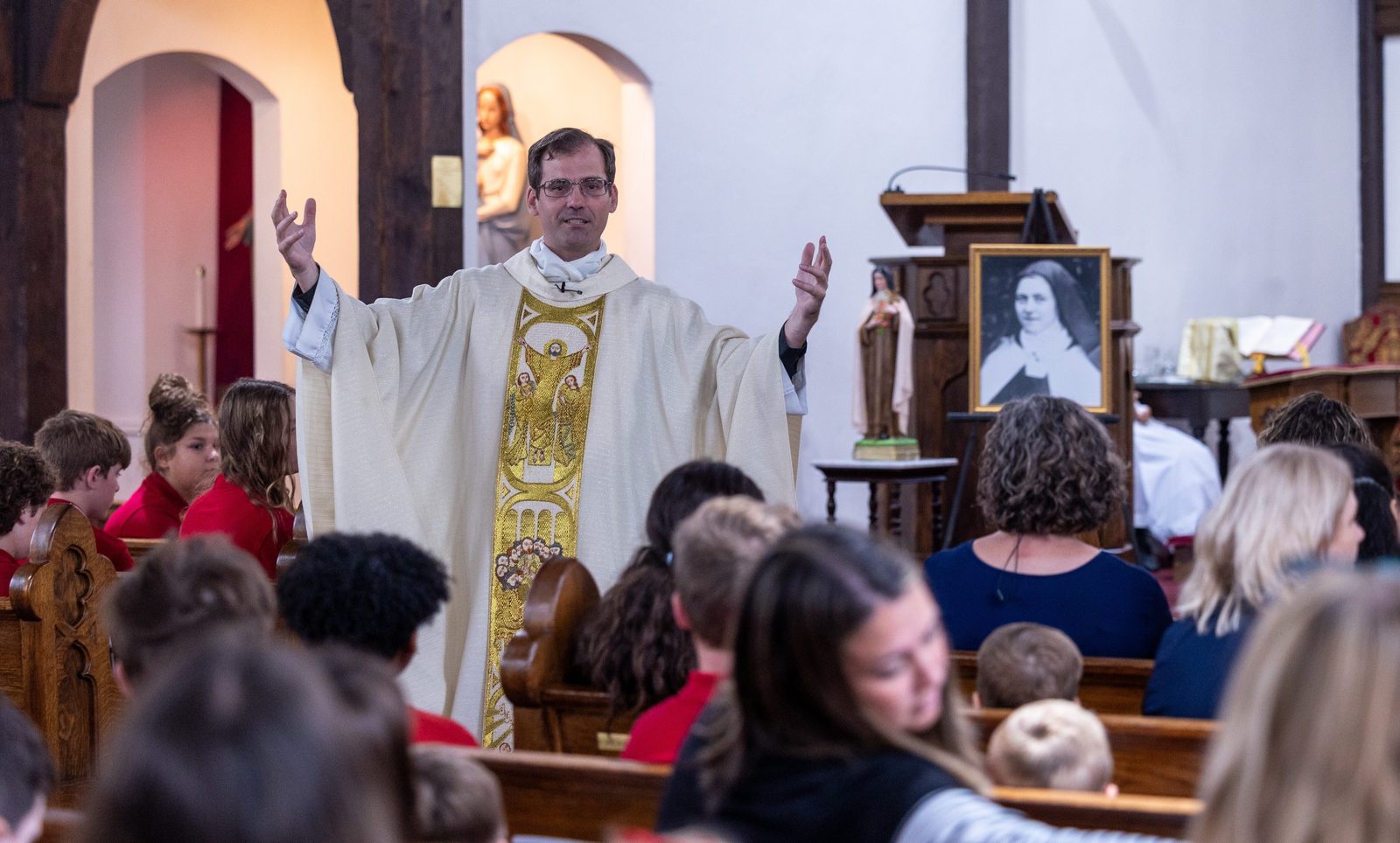 Father Scott Holmer, the pastor of Holy Face Parish in Great Mills, Maryland, gives the homily during a Mass in Holy Face Church on Oct. 1, 2024 for students at Little Flower School in Great Mills, to mark the feast day of their school’s patron saint, St. Thérѐse of Lisieux, who is known as the Little Flower. (Catholic Standard photo by Mihoko Owada)