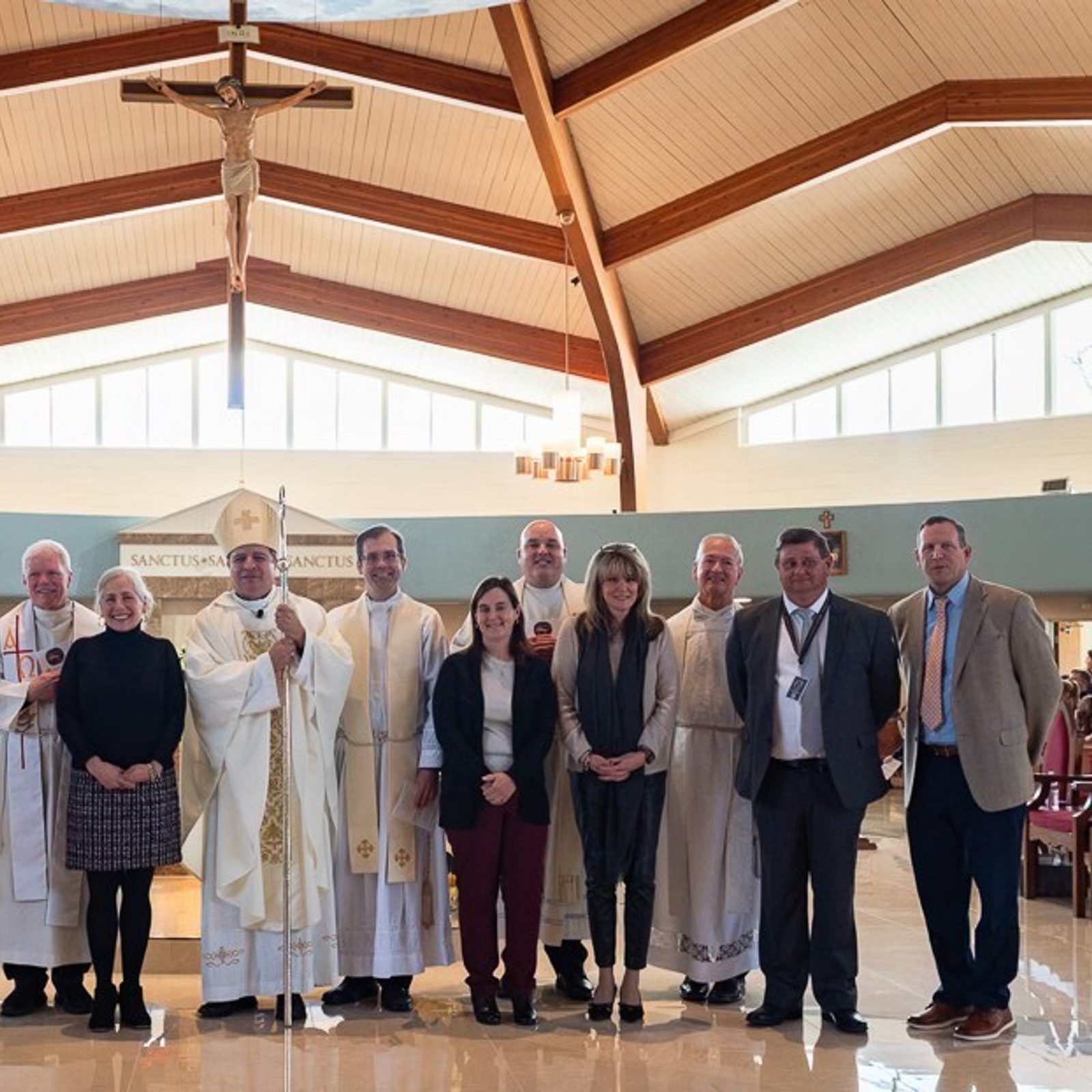 After the Catholic Schools Week Mass for St. Mary’s County Catholic schools on Jan. 22, 2026 celebrated by Washington Auxiliary Bishop Evelio Menjivar, he posed for a photo with principals and pastors from those schools and parishes. From left to right Caitlin Keeton, the principal of Little Flower School in Great Mills; Father Christian Huebner, the administrator of Immaculate Heart of Mary Parish in Lexington Park where the Mass was celebrated; Father David Beaubien, the pastor of St. Aloysius Parish in Leonardtown; Janet Szoch, the principal of Father Andrew White, S.J. School in Leonardtown; Bishop Evelio Menjivar; Father Scott Holmer, the pastor of Holy Face Parish in Great Mills; Mary Van Ryswick, the principal of St. Michael’s School in Ridge; Father Keith Burney, the pastor of St. Michael’s Parish in Ridge; Susan McDonough, the principal of St. John’s School in Hollywood; Father Ray Schmidt, the pastor of St. John Francis Regis Parish in Hollywood; Anthony Wojt, the principal of Mother Catherine Academy in Mechanicsville; and Chris Buchleitner, the associate superintendent in the Catholic Schools Office of the Archdiocese of Washington. (Catholic Standard photo by Nicole Olea)