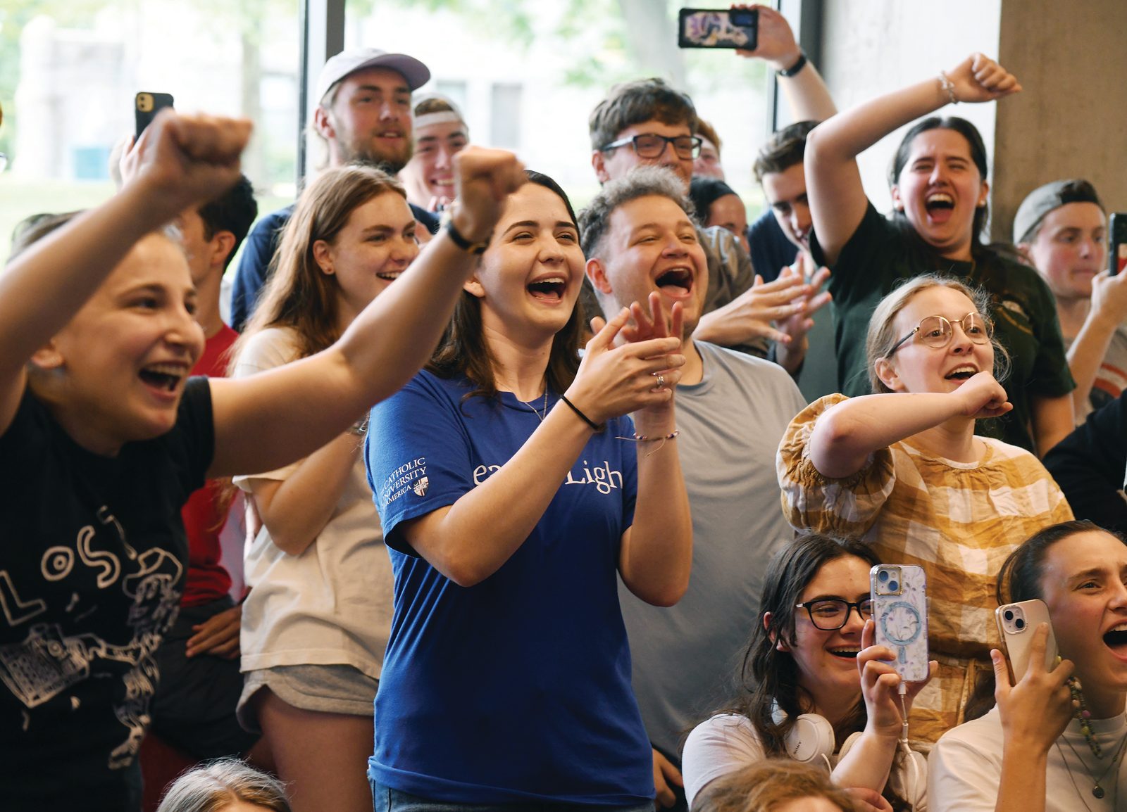 Students at The Catholic University of America witness the first appearance of Pope Leo XIV while watching the jumbo TV screens at Murphy's Pub on campus on May 8, 2025. (Photo by Patrick G. Ryan, University Photographer)