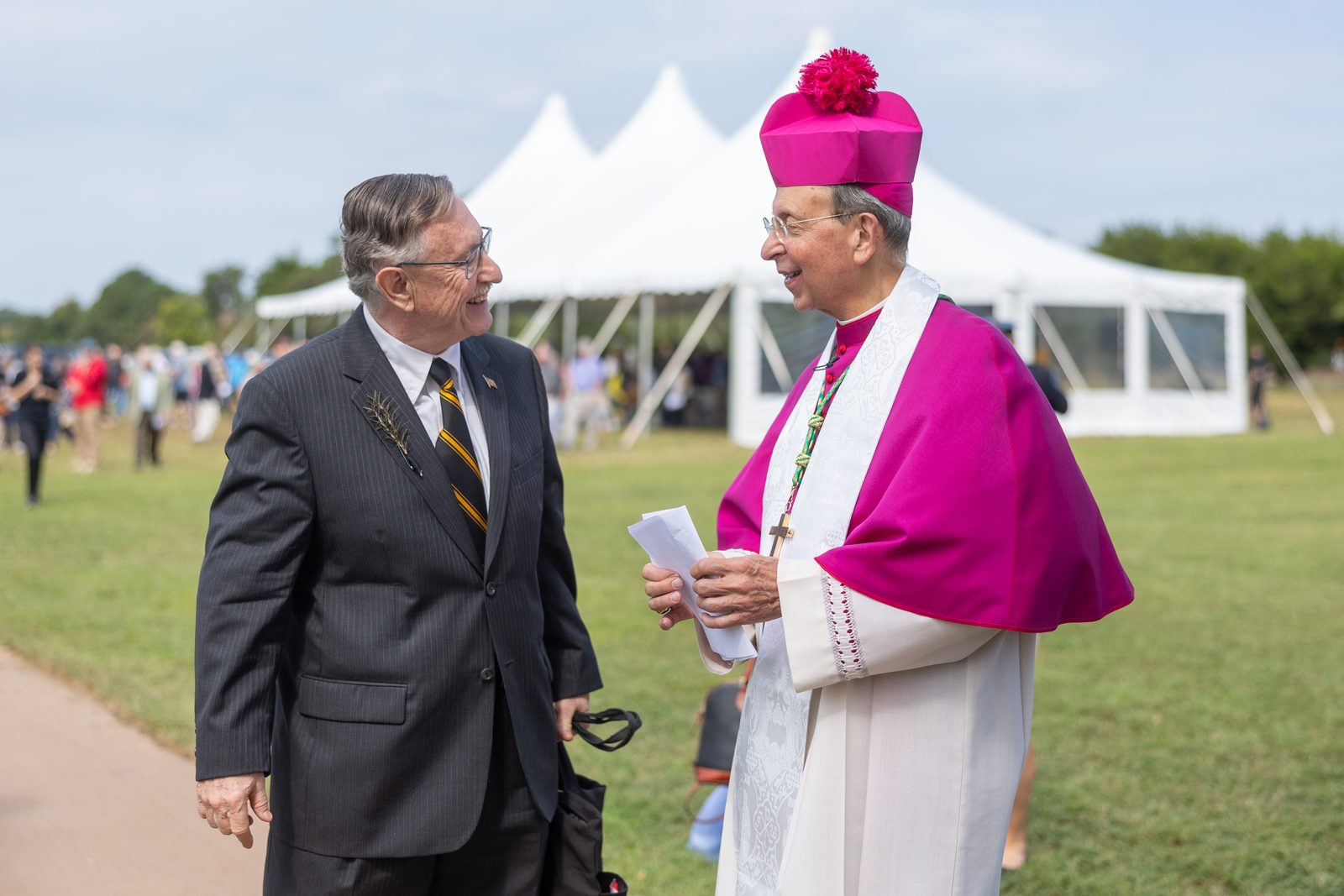 Historical archaeologist Dr. Henry Miller visits with Baltimore Archbishop William E. Lori after the reinterment ceremony for the remains of eight young children from colonial-era Maryland that were brought back to the site of the rebuilt 1667 Brick Chapel in Historic St. Mary’s City on Sept. 20, 2025. Archbishop Lori presided at the reinterment rite. Miller, a Maryland Heritage Scholar and the Senior Research Fellow at Historic St. Mary’s City, spoke at the ceremony, describing how the remains of 65 colonial-era Marylanders buried near the foundation of the original brick chapel were carefully removed so the reconstructed chapel could be built at the site. The reinterment rite marked the return of the remains of those early Marylanders to the site where they had been buried. (Catholic Standard photo by Mihoko Owada)