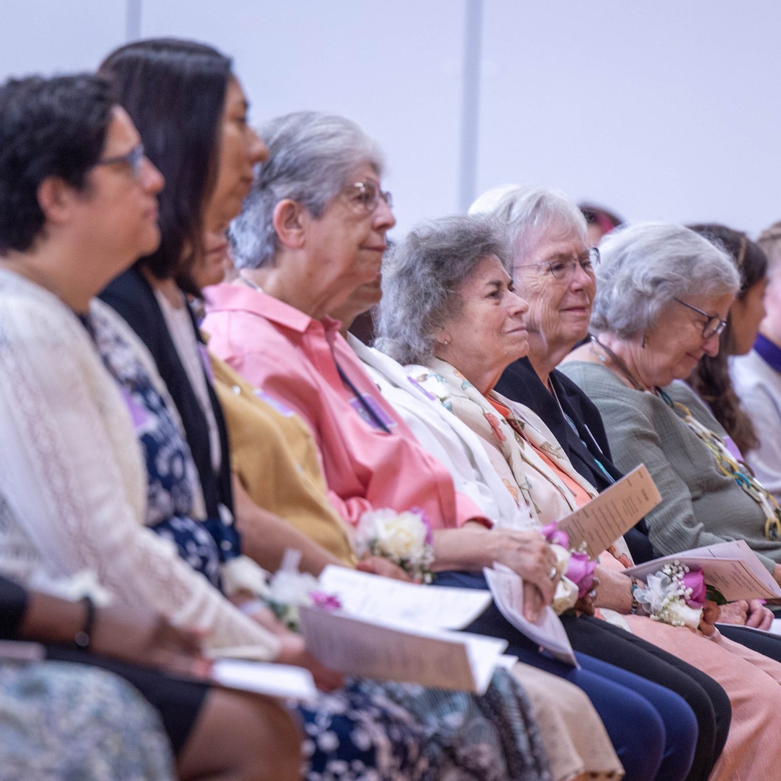 During a Sept. 13 Mass at The Academy of the Holy Cross in Kensington, Sisters of the Holy Cross, at center along with Katy Prebble, the school’s retired president, join students, faculty and staff members for the liturgy celebrated by Washington Cardinal Wilton Gregory to mark the Feast of the Exaltation of the Holy Cross. At the far right in the photo is Emily A. Kasof, the new president of The Academy of the Holy Cross. (Catholic Standard photo by Mihoko Owada)