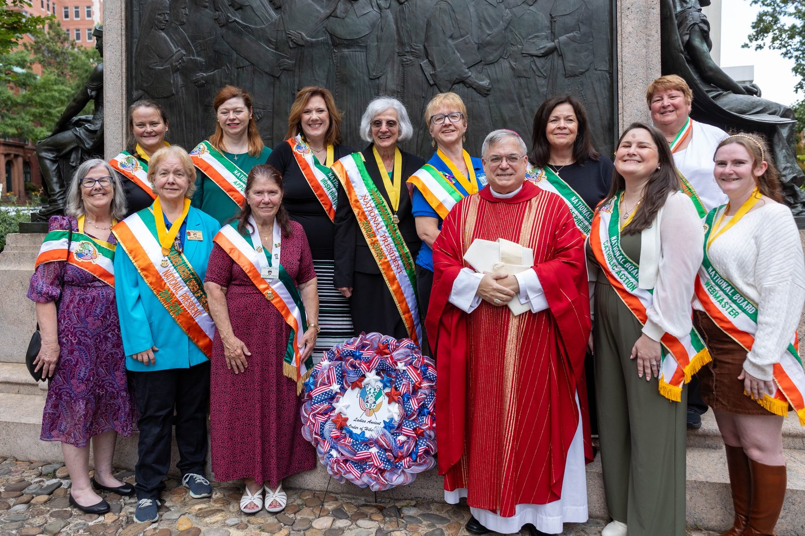 Leaders of the Ladies Ancient Order of Hibernians, joined by Bishop Alfred Schlert of Allentown, Pennsylvania, the group’s national chaplain, pose for a photo at the Nuns of the Battlefield Monument across the street from the Cathedral of St. Matthew the Apostle in downtown Washington, D.C., on Sept. 21, 2024, following a Mass celebrated by Cardinal Wilton Gregory marking the 100th anniversary of the 1924 dedication of the monument. After the Mass, Cardinal Gregory offered prayers rededicating the monument, and then a ceremony was held where a new wayside marker offering an overview of the monument was dedicated. The Ladies Ancient Order of Hibernians, an Irish American Catholic group, led the drive to establish the monument 100 years ago, and also led the effort to erect the wayside marker to mark the monument’s centennial. Most of the women religious who served as nurses during the Civil War were Irish Americans. (Catholic Standard photo by Mihoko Owada)