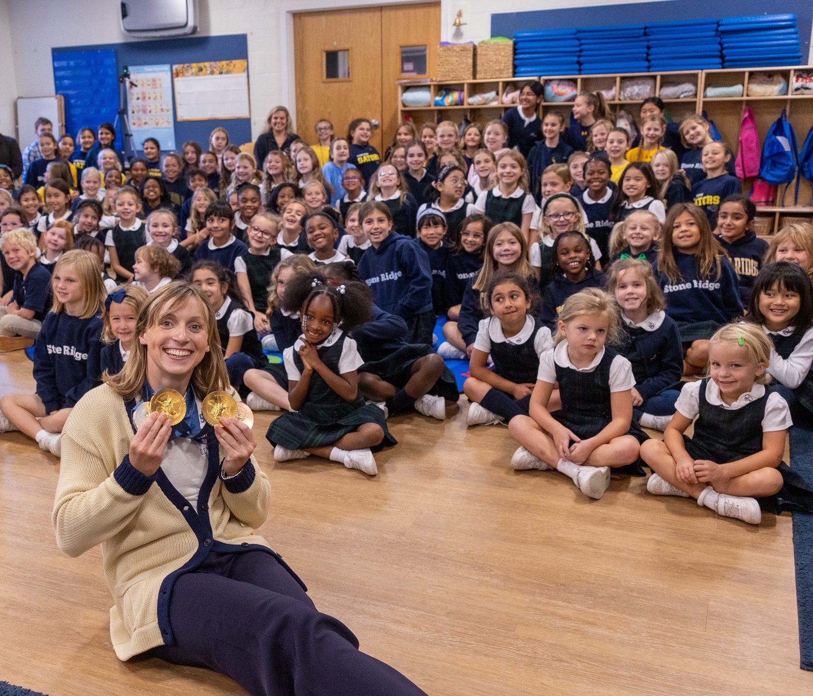 Olympic champion swimmer Katie Ledecky poses for a photo with Lower School students during a visit to her alma mater, Stone Ridge School of the Sacred Heart in Bethesda, Maryland, on Oct. 22, 2024. (Catholic Standard photo by Mihoko Owada)