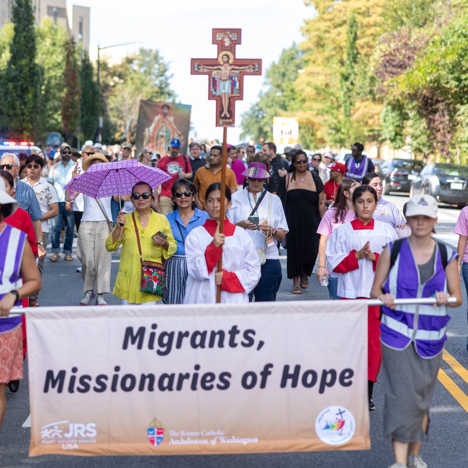People march in a procession for the 111th World Day of Migrants and Refugees on Sept. 28, 2025 that began at the Shrine of the Sacred Heart in Washington, D.C., wound down 16th Street, and concluded at the Cathedral of St. Matthew the Apostle, where Cardinal Robert W. McElroy celebrated a Mass marking that day. (Catholic Standard photos by Mihoko Owada)