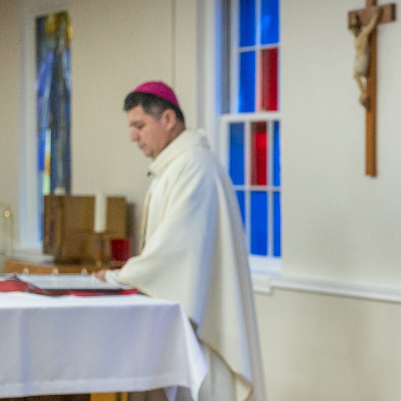 Mary O’Meara, the executive director of the Office of Deaf and Disabilities Ministry of The Roman Catholic Archdiocese of Washington, offers sign language interpretation during a May 11 Mass hosted by that office at the Pope Francis Center in Landover Hills for people living with mental health challenges. At left is Washington Auxiliary Bishop Evelio Menjivar, the main celebrant at the Mass. (Catholic Standard photo by Mihoko Owada)