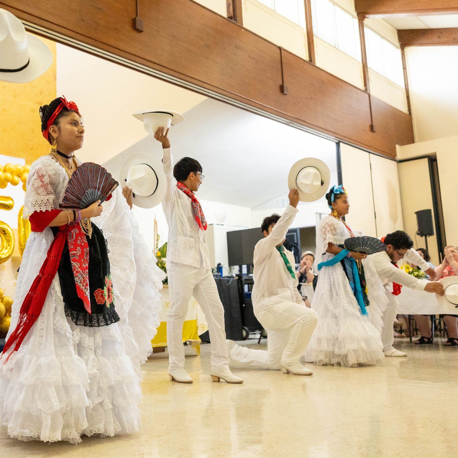 Youth at a June 30 reception celebrating the 50th anniversary of Mother Seton Parish in Germantown, Maryland, perform a traditional Mexican dance (photo above) and Asian dance (photo below). (Catholic Standard photos by Mihoko Owada)