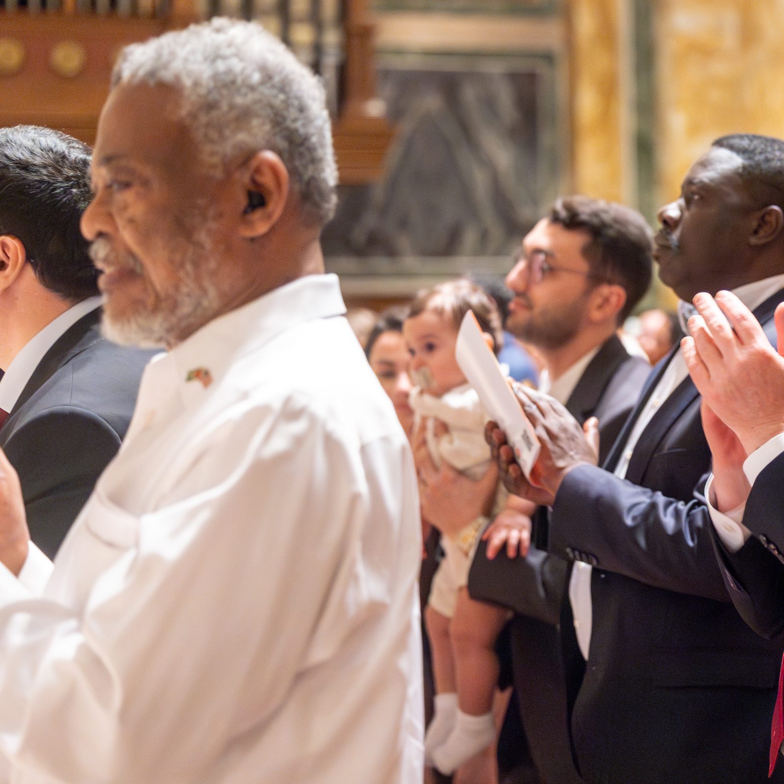 Feligreses aplauden de pie al cardenal Robert McElroy, luego de concluir su homilía, durante la misa por la Jornada Mundial del Migrante y del refugiado celebrada, en la catedral de San Mateo Apóstol, el 28 de septiembre de 2025.