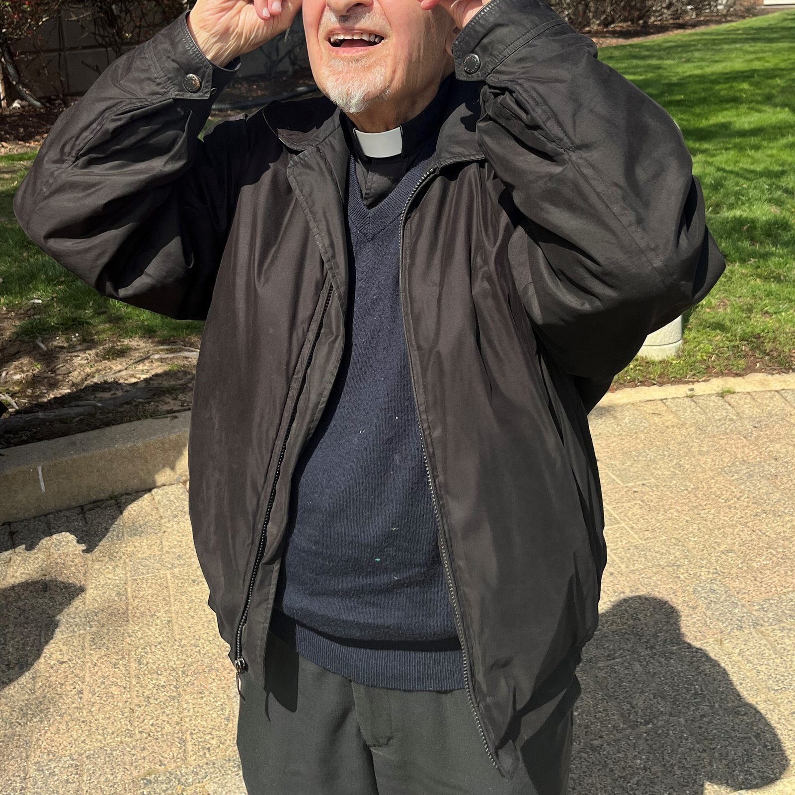 Msgr. Joseph Ranieri views the solar eclipse on April 8, 2024 outside the Archdiocesan Pastoral Center in Hyattsville, Maryland. (Catholic Standard photo by Mark Zimmermann)