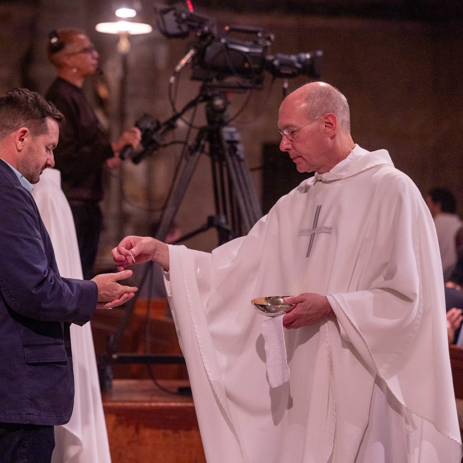 Msgr. Walter Rossi, the rector of the Basilica of the National Shrine of the Immaculate Conception, gives Communion to a man during a Mass of Thanksgiving on Aug. 22, 2024 at the basilica’s Crypt Church that commemorated the centennial of the first priestly ordinations at the National Shrine in 1924. (Catholic Standard photo by Mihoko Owada)