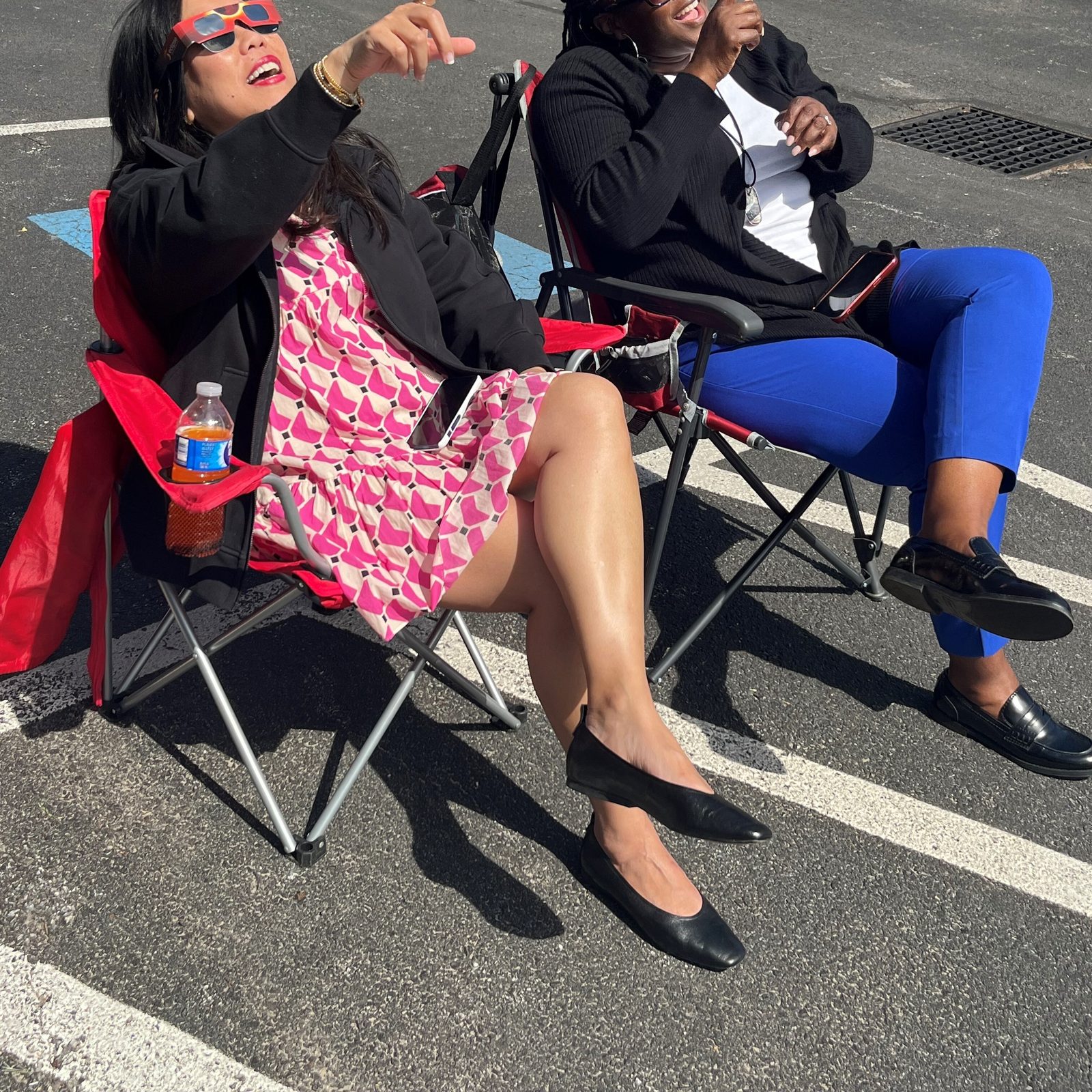 Nanette Lowe and LaKeisha Baylor of the Human Resources Department of The Roman Catholic Archdiocese of Washington view the solar eclipse outside the Archdiocesan Pastoral Center in Hyattsville, Maryland on April 8, 2024. (Catholic Standard photo by Mark Zimmermann)