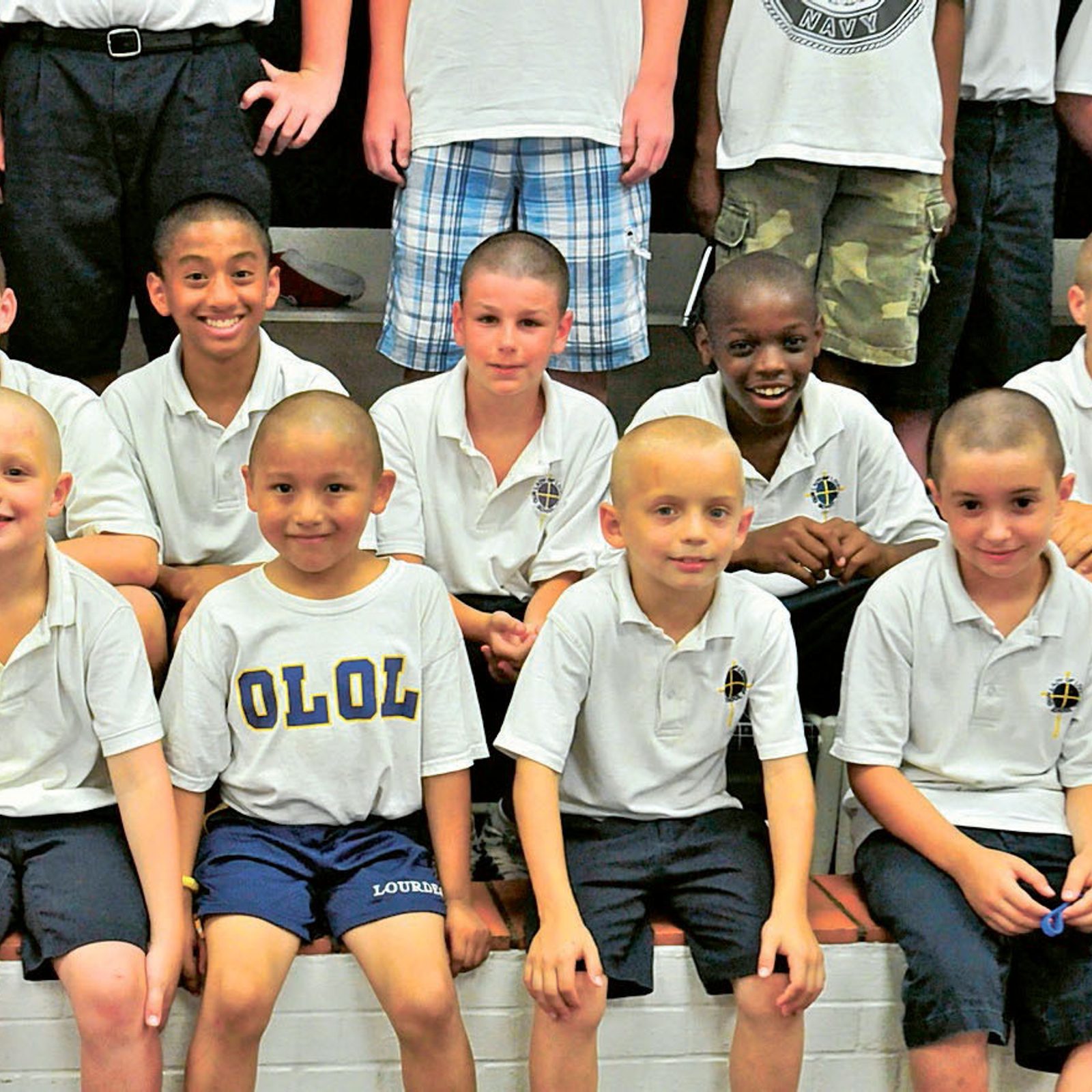 In the spring of 2011, 71 boys at Our Lady of Lourdes School in Bethesda, Maryland, had their heads shaved to show solidarity for their teacher, Kate Truax, who had cancer. After she died in 2012 at the age of 30, two busloads of Lourdes students, faculty and parents attended her Funeral Mass at the Cathedral of Mary Our Queen in Baltimore. (Catholic Standard file photo by Michael Hoyt)