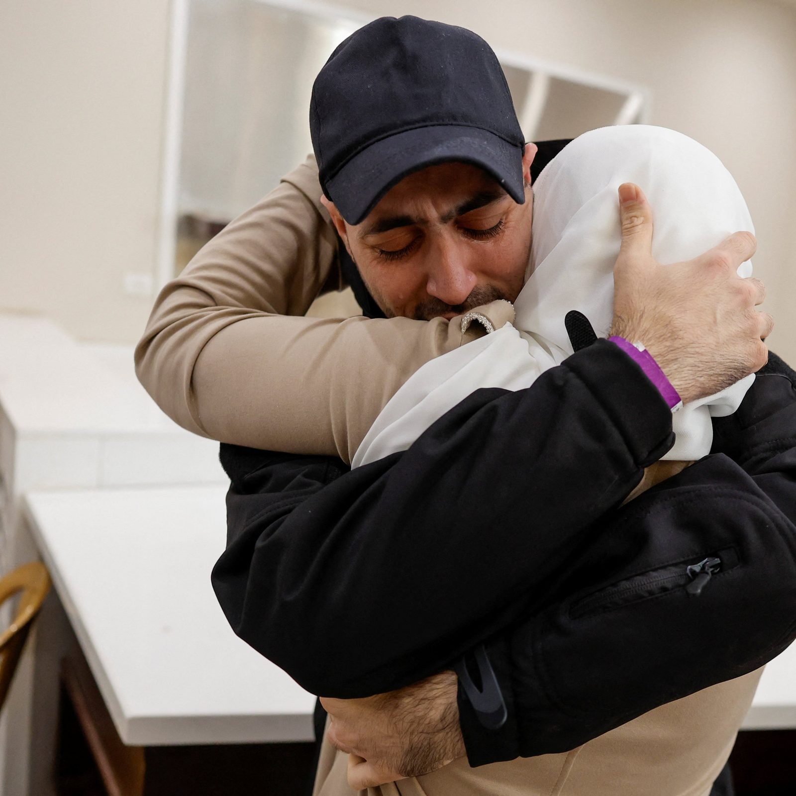 A freed Palestinian prisoner is embraced by a family member in Ramallah, in the Israeli-occupied West Bank, Oct. 13, 2025, after being released from an Israeli jail as part of a hostages-prisoners swap and a ceasefire deal in Gaza between Hamas and Israel. (OSV News photo/Ammar Awad, Reuters)