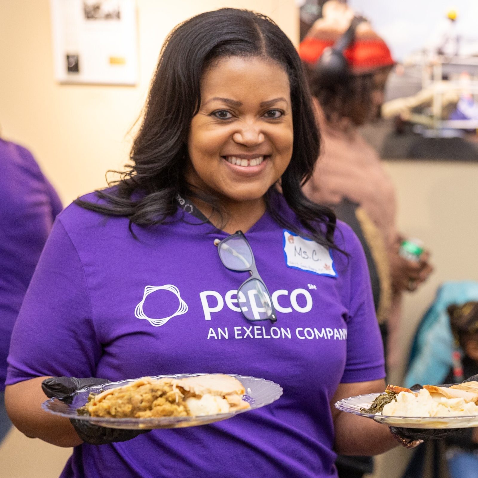 In the photos above and below, volunteers from Pepco prepare to serve meals to guests at a Thanksgiving dinner on Nov. 26 given through Catholic Charities’ St. Maria’s Meals program and hosted by Pepco at its Edison Place Gallery in downtown Washington, D.C. (Catholic Standard photos by Mihoko Owada)