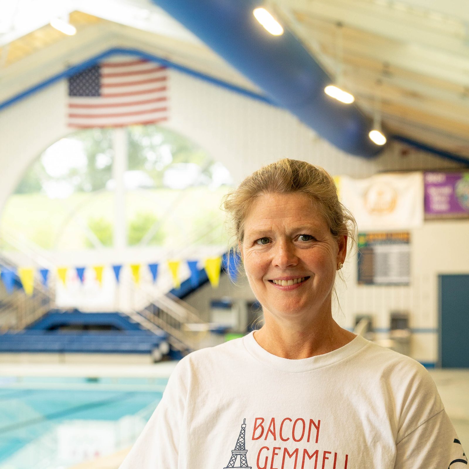 Philippa Bacon, the mother of Olympic swimmer Phoebe Bacon, stands at the Aquatic Center at Stone Ridge School of the Sacred Heart in Bethesda before a July 25 pep rally at the school celebrating three of its graduates, including Phoebe, a member of Stone Ridge’s class of 2020, who are competing in the 2024 Summer Olympics in Paris. Stone Ridge’s other Olympic swimmers celebrated at the pep rally were Katie Ledecky of the class of 2015 and Erin Gemmell of the class of 2023. (Catholic Standard photo by Mihoko Owada)