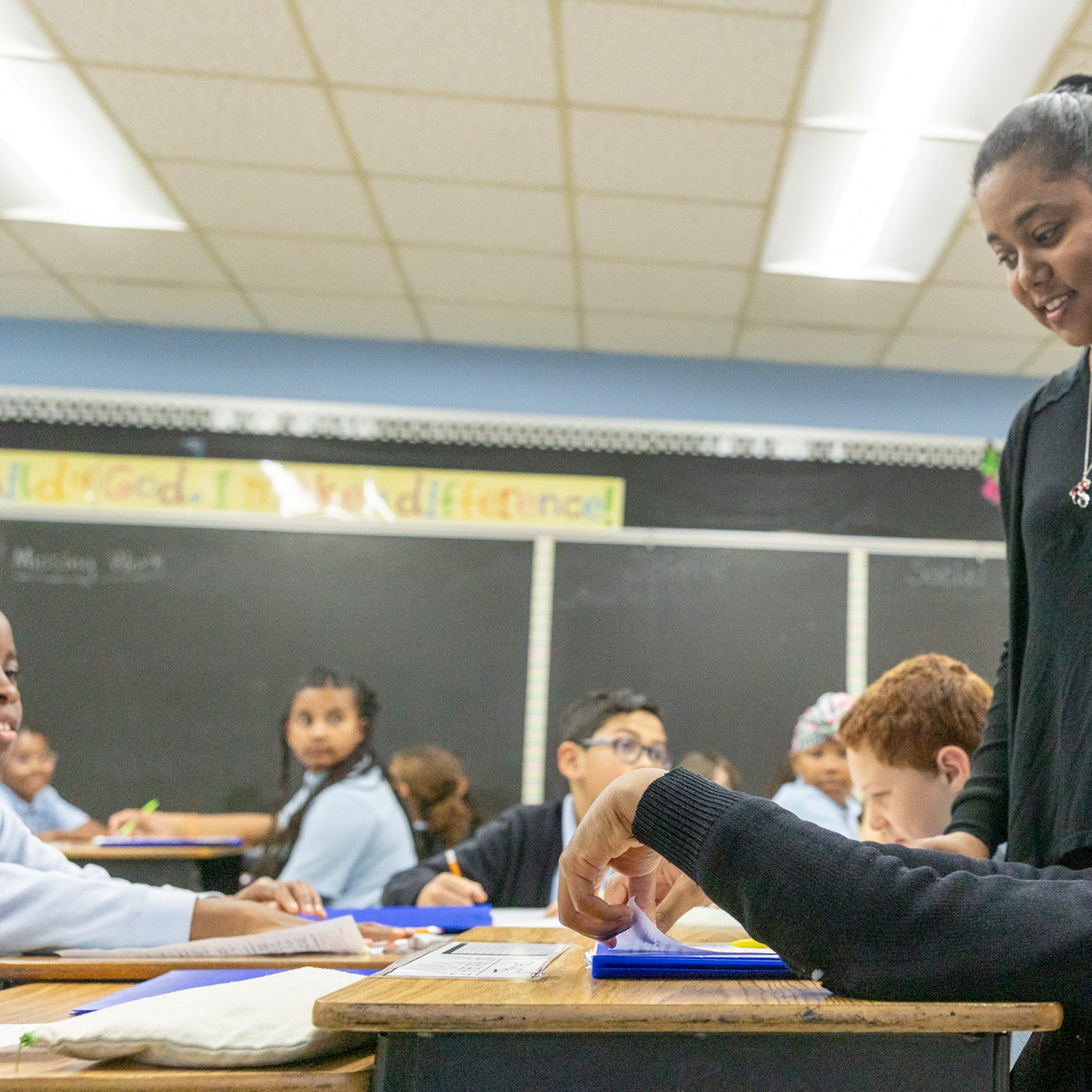 Renee Clark, the resource teacher at St. Mary of the Assumption Catholic School in Upper Marlboro, who is a 2024 Golden Apple Award-winning Catholic school teacher, helps a student in a class at her school. (Catholic Standard photo by Mihoko Owada)