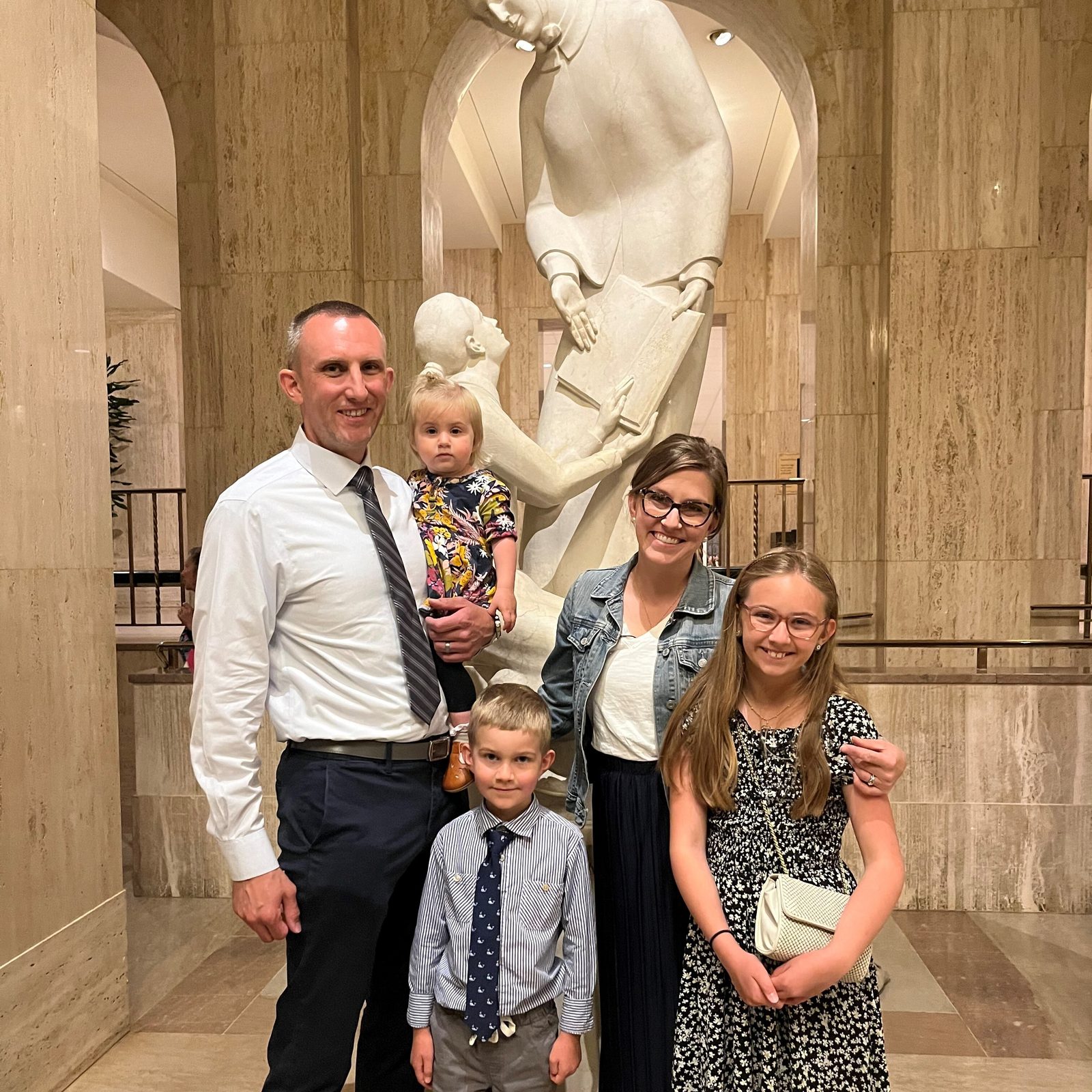 Tony and Alison Rizzuto of Burke, Virginia, accompanied by their daughter Charlotte, 10, their son Leo, 6, and their baby daughter Penelope, 1, participated in the Eucharistic procession winding through the Brookland neighborhood in Washington, D.C., on June 8, 2024. The next day, they attended the National Eucharistic Pilgrimage Mass at the Basilica of the National Shrine of the Immaculate Conception. Beforehand, they posed for a photo near the basilica’s statue of St. Elizabeth Ann Seton, the first American-born saint. The Eastern route of the National Eucharistic Pilgrimage is named in that saint’s honor. (Catholic Standard photo by Mark Zimmermann)