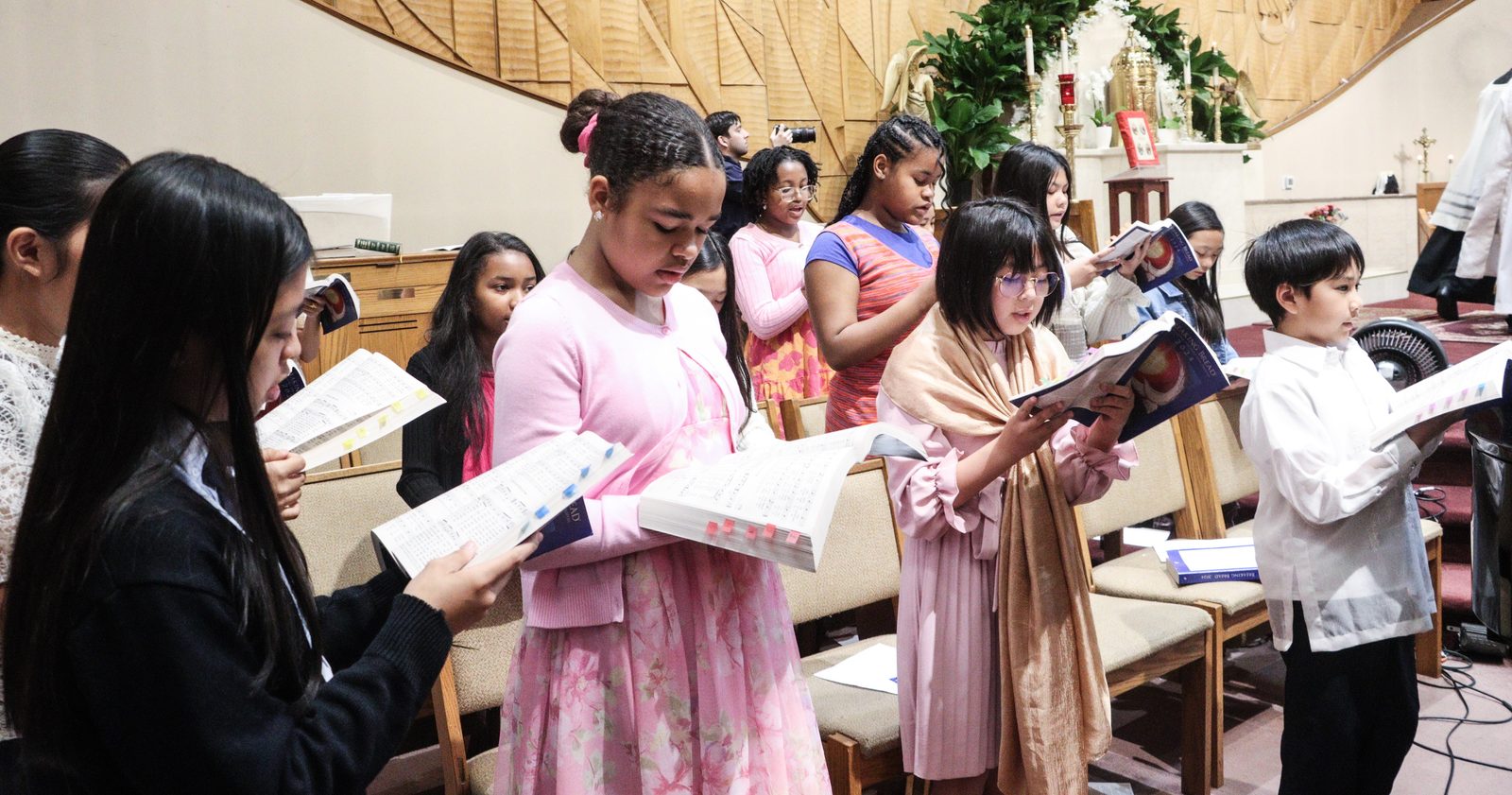 A student choir from St. Columba School in Oxon Hill, Maryland, helps lead the singing during a Mass on May 3, 2024 at St. Columba Church to mark Asian American and Pacific Islander Heritage Month. (Catholic Standard photo by Javier Diaz)