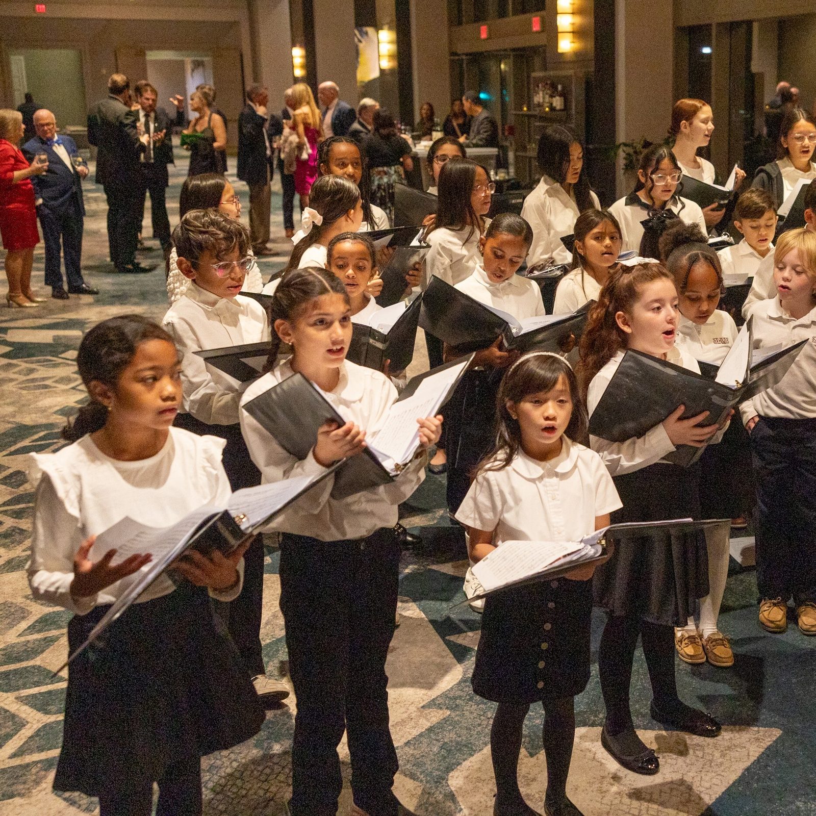 Students in the choir from St. Jude Regional Catholic School in Rockville, Maryland, sing at the reception for the 31st annual Catholic Business Network of Montgomery County Gala held on Nov. 22, 2024 at the Bethesda North Marriott Hotel & Conference Center. (Catholic Standard photo by Mihoko Owada)