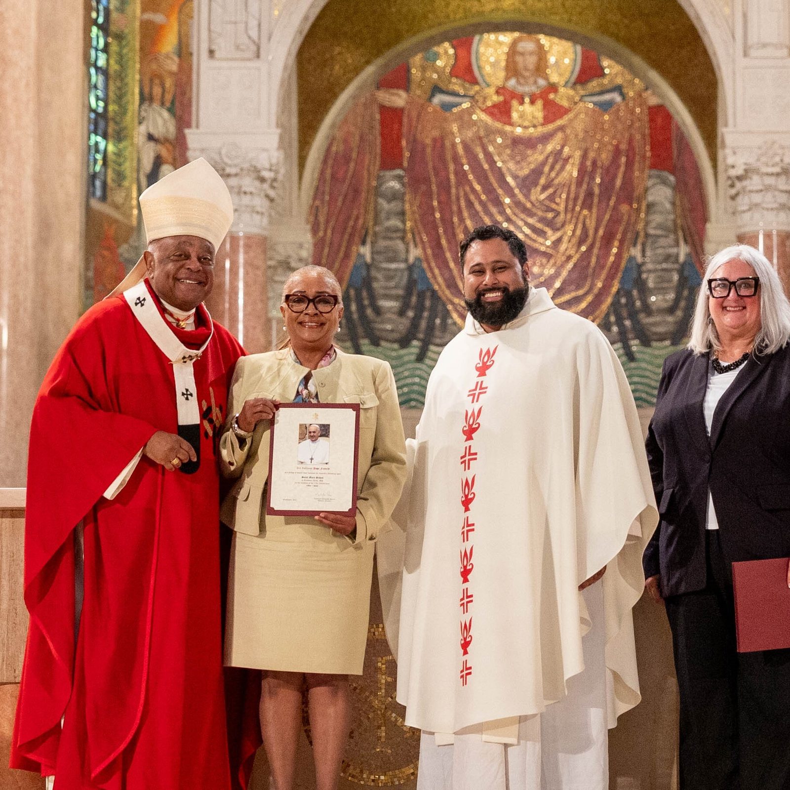 At the Opening of Schools Mass on Aug. 26 at the National Shrine, the local Catholic schools celebrating milestone anniversaries this year included St. Mary’s School in Landover Hills, Maryland, which is marking its 70th anniversary. From left to right are Cardinal Wilton Gregory; LaSandra Hayes, St. Mary’s principal; Father Mario Majano, St. Mary’s pastor; and Kelly Branaman, the Secretary for Catholic Schools and Superintendent of Schools for The Roman Catholic Archdiocese of Washington. (Catholic Standard photo by Mihoko Owada)