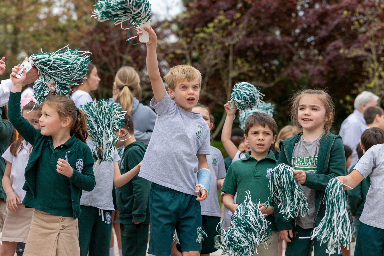 After it was announced on April 17 that Michelle Roche, a fourth grade teacher at St. Raphael School in Rockville, is a 2024 Golden Apple Award winning teacher, St. Raphael’s students gathered in the school’s courtyard and cheered for her, including, from left to right, kindergarten students Bridget Dowd, Michael Manders, Rocco Petrrucelli and Anna Mahan. (Catholic Standard photo by Mihoko Owada)