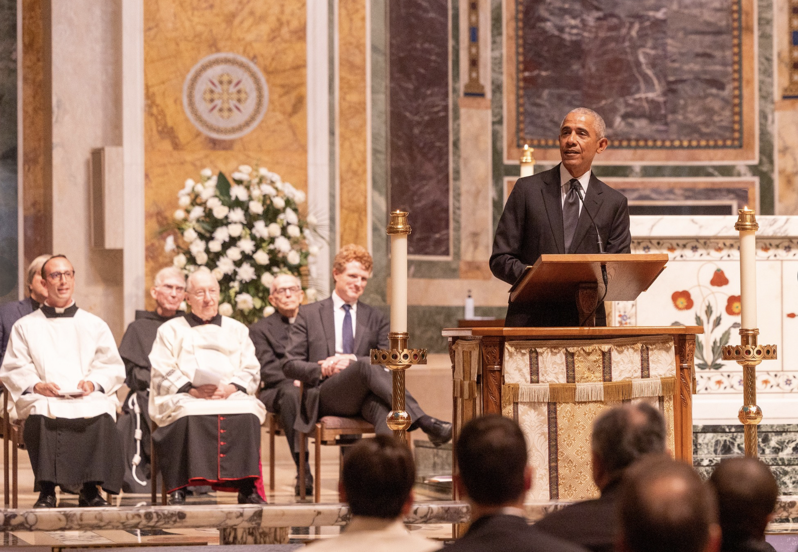 Former President Barack Obama speaks during a celebration of the life of the late Ethel Kennedy held on Oct. 16, 2024 at the Cathedral of St. Matthew the Apostle in Washington, D.C. Seated at left are Father Joseph McHenry, a parochial vicar there; Msgr. W. Ronald Jameson, the cathedral’s rector; and Joseph Kennedy III, a grandson of Ethel Kennedy. (Catholic Standard photo by Mihoko Owada)
