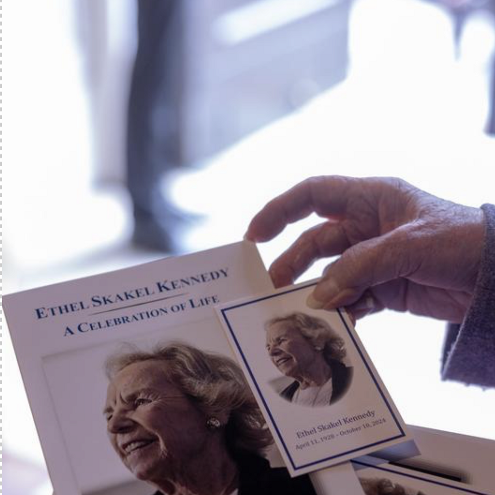 An usher holds programs and memorial cards that were handed out during a celebration of the life of the late Ethel Skakel Kennedy on Oct. 16, 2024 at St. Matthew’s Cathedral in Washington, D.C.. She died on Oct. 10 at the age of 96. (Catholic Standard photo by Mihoko Owada)