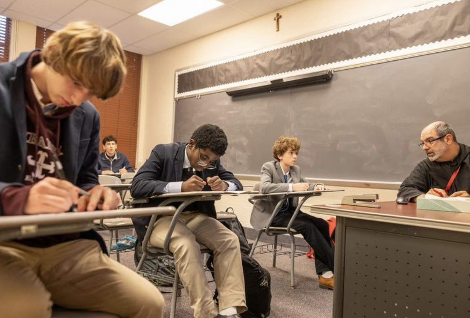 Benedictine Father Ignacio Gonzalez teaches a Spanish class to students at St. Anselm's Abbey School in Washington on Dec. 11, 2024. Father Ignacio, the director of campus ministry at St. Anselm's Abbey School, also teaches religion there. (Catholic Standard photo by Mihoko Owada)