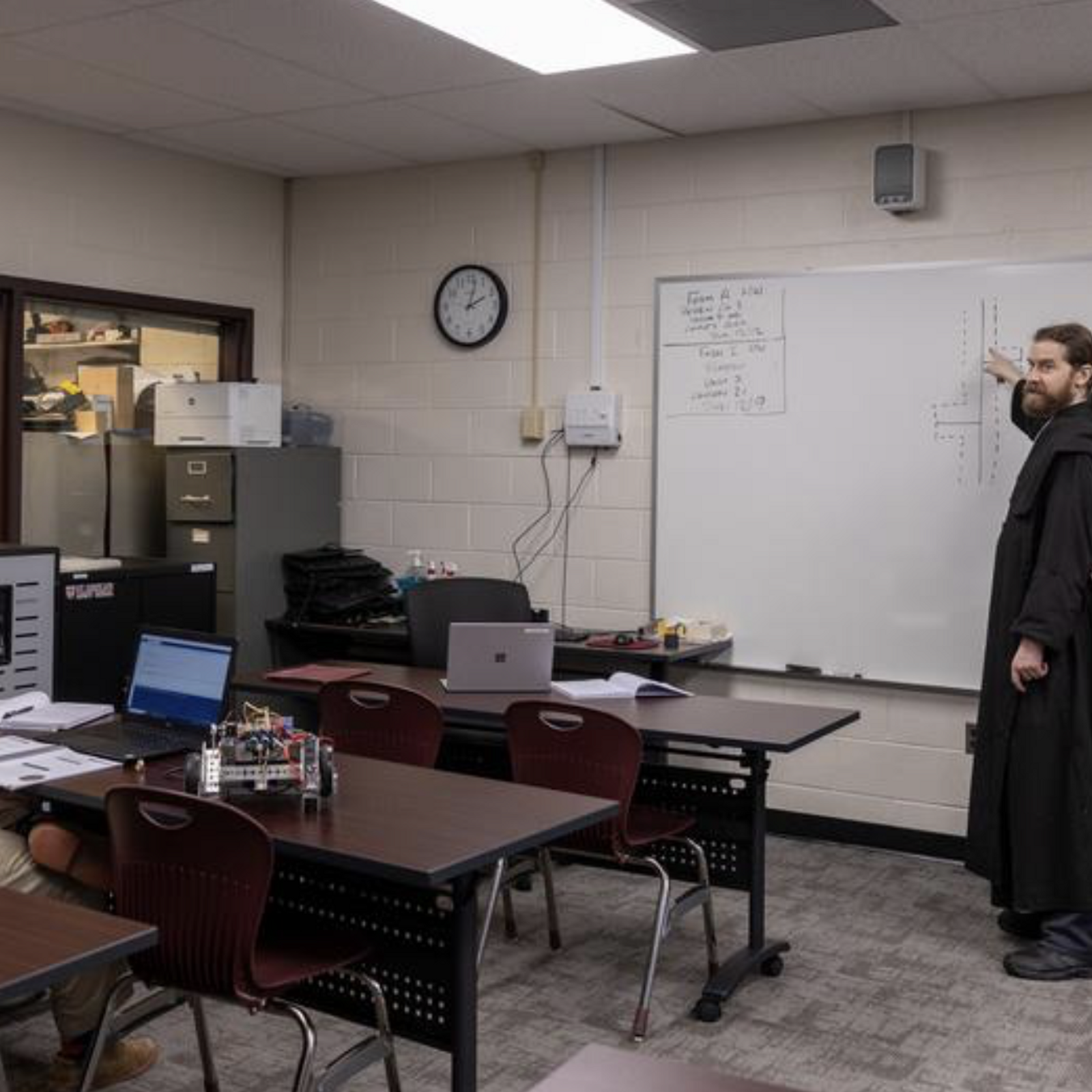 Benedictine Father Samuel Springuel teaches robotics to 12th grade student Tim Burke at St. Anselm's Abbey School in Washington on Dec. 11, 2024. Father Samuel, the novice master at St. Anselm's Abbey, serves as a robotics and computer science teacher at the school. (Catholic Standard photo by Mihoko Owada)