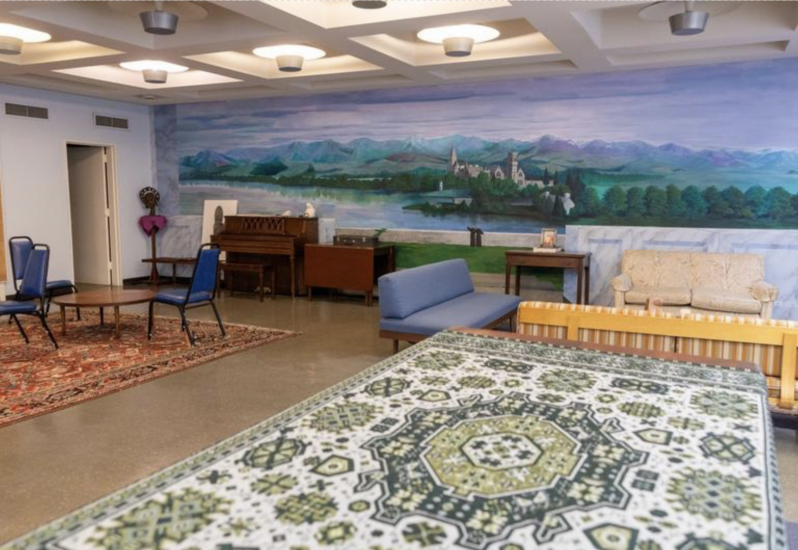 The large painting on the wall was painted by one of the monks in the Fort Augustus Room at St. Anselm's Abbey in Washington. One of the monastery's community rooms is used sometimes for community gatherings, including for coffee and refreshments after the midnight Christmas Mass. The abbey also sometimes opens this room for group meetings. (Catholic Standard photo by Mihoko Owada)
