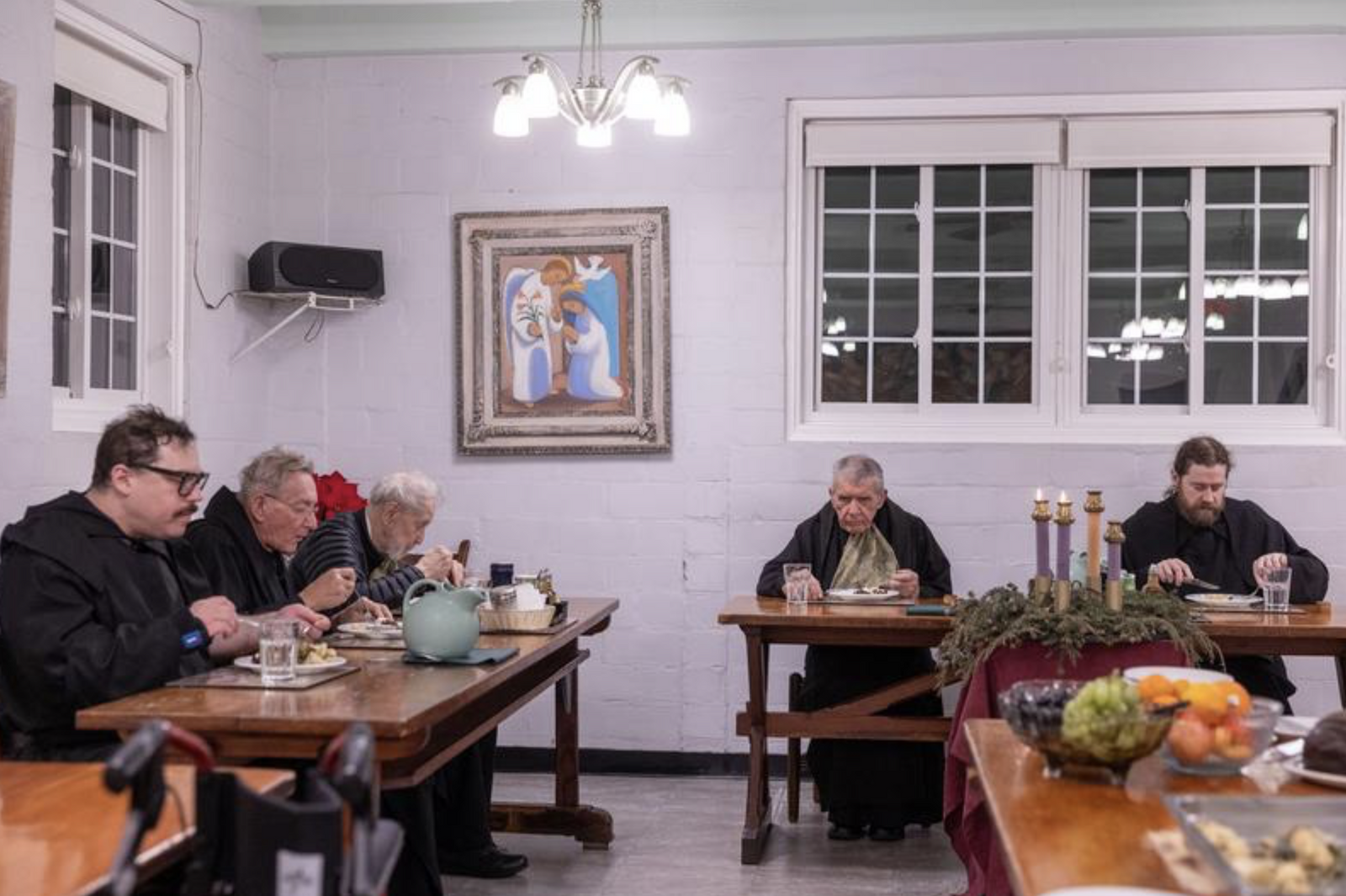 During a silent dinner at St. Anselm’s Abbey in Washington. the monks eat their meals in the refectory while they listen to a table book reading by Benedictine Father Gabriel Myers on Dec. 11, 2024. From left to right are Benedictine Brother Cyprian Morales, Benedictine Father Peter Weigand, Benedictine Father Joseph Jensen, Abbot James Wiseman, and Benedictine Father Samuel Springuel. (Catholic Standard photo by Mihoko Owada)