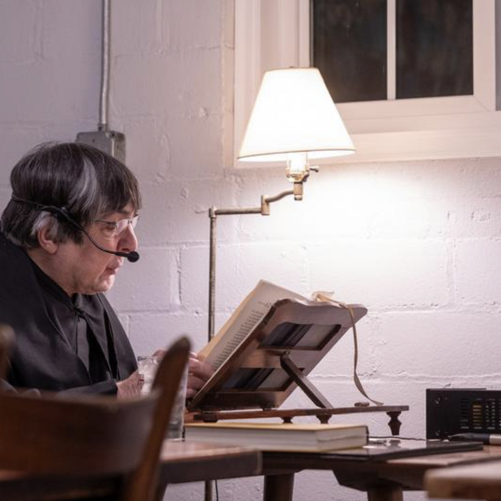 At a silent dinner at St. Anselm's Abbey in Washington on Dec. 11, 2024, Benedictine Father Gabriel Myers reads a book in the refectory. (Catholic Standard photo by Mihoko Owada)