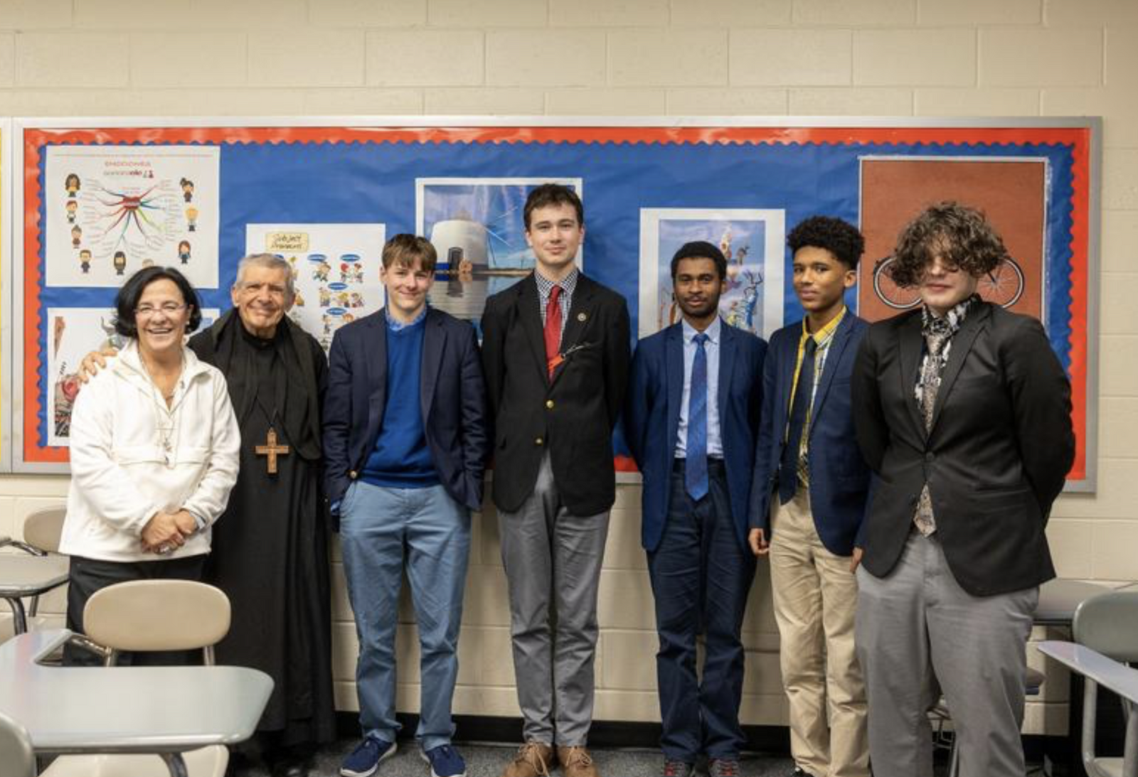 After the Spanish Language III class at St. Anselm's Abbey School, everyone poses for a photo. From left to right are the teacher, Belen Fernandez, Abbot James Wiseman, and 10th grade students Cole Stanek, Henry Sloan, Ronald Holley, Yadier Johnson and Carlo Tedeschi. (Catholic Standard photo by Mihoko Owada)