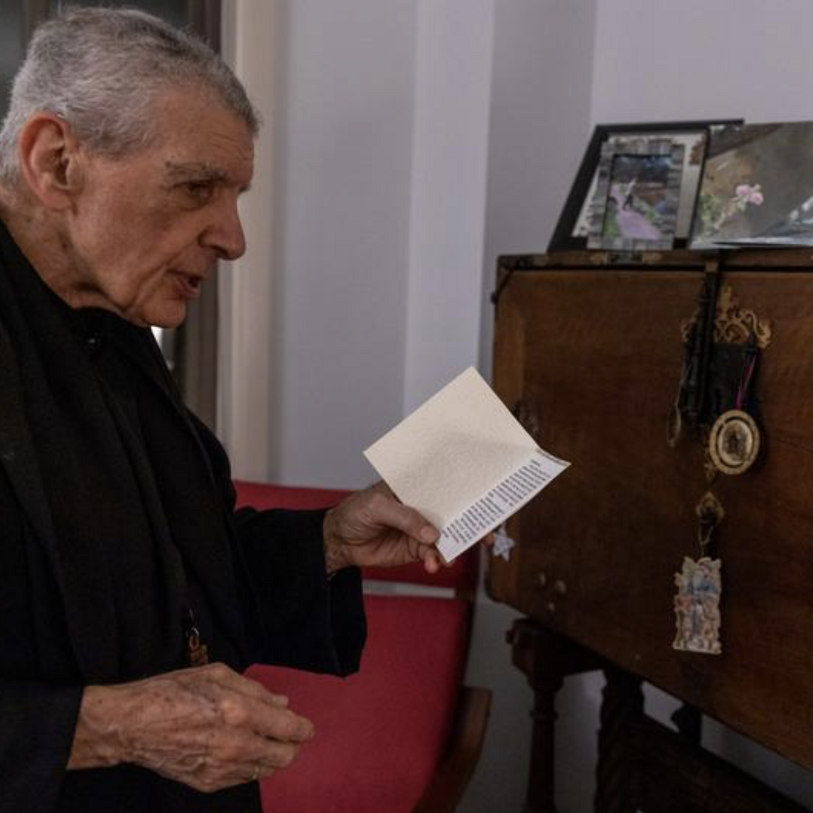 In his office at St. Anselm's Abbey in Washington on Dec. 11, 2024, Abbot James Wiseman shows memorable cards and gifts from his family and friends, including one from his sister. (Catholic Standard photo by Mihoko Owada)